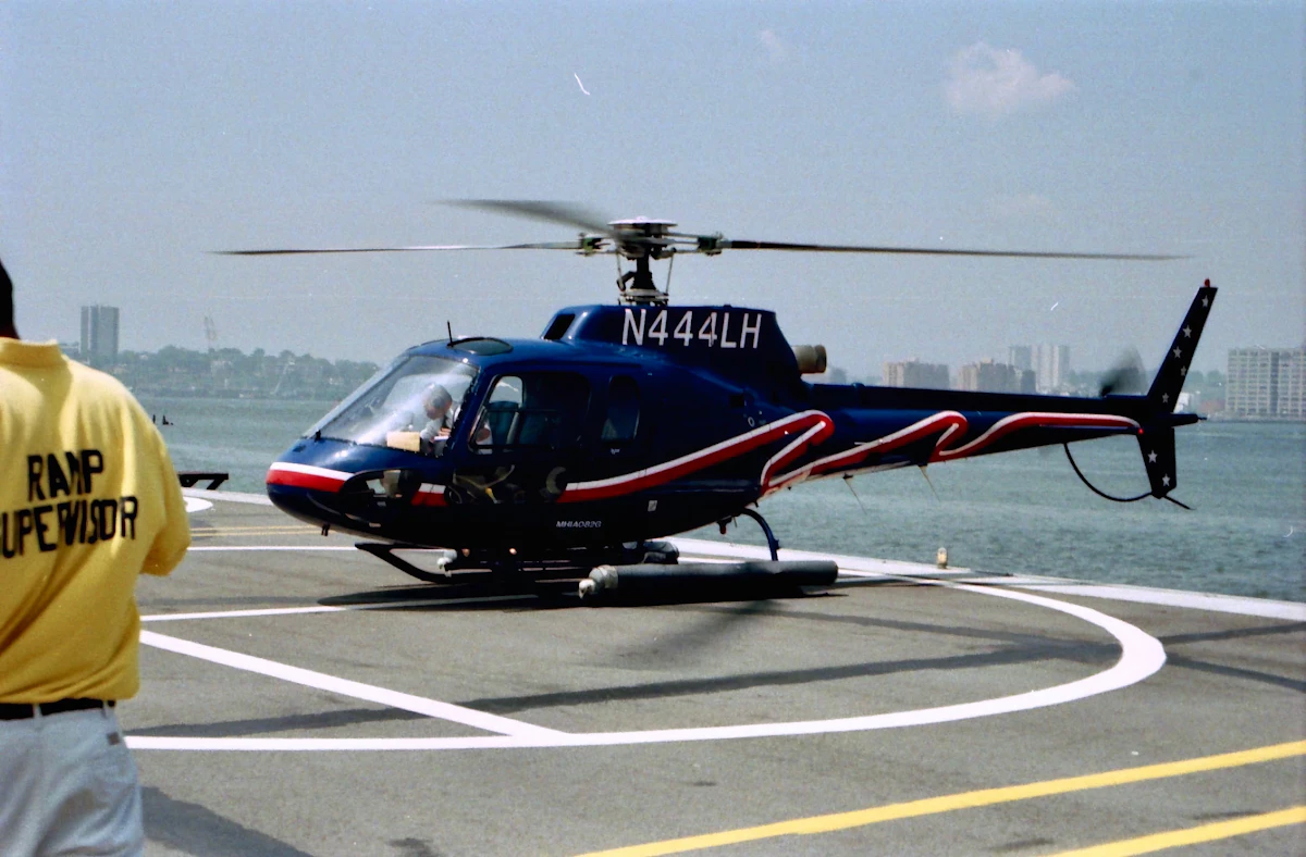A helicopter on a waterfront helipad, the city-centre advantage in the helicopter vs private jet comparison