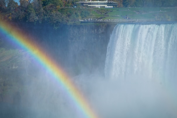 Rainbow over a powerful waterfall in mist