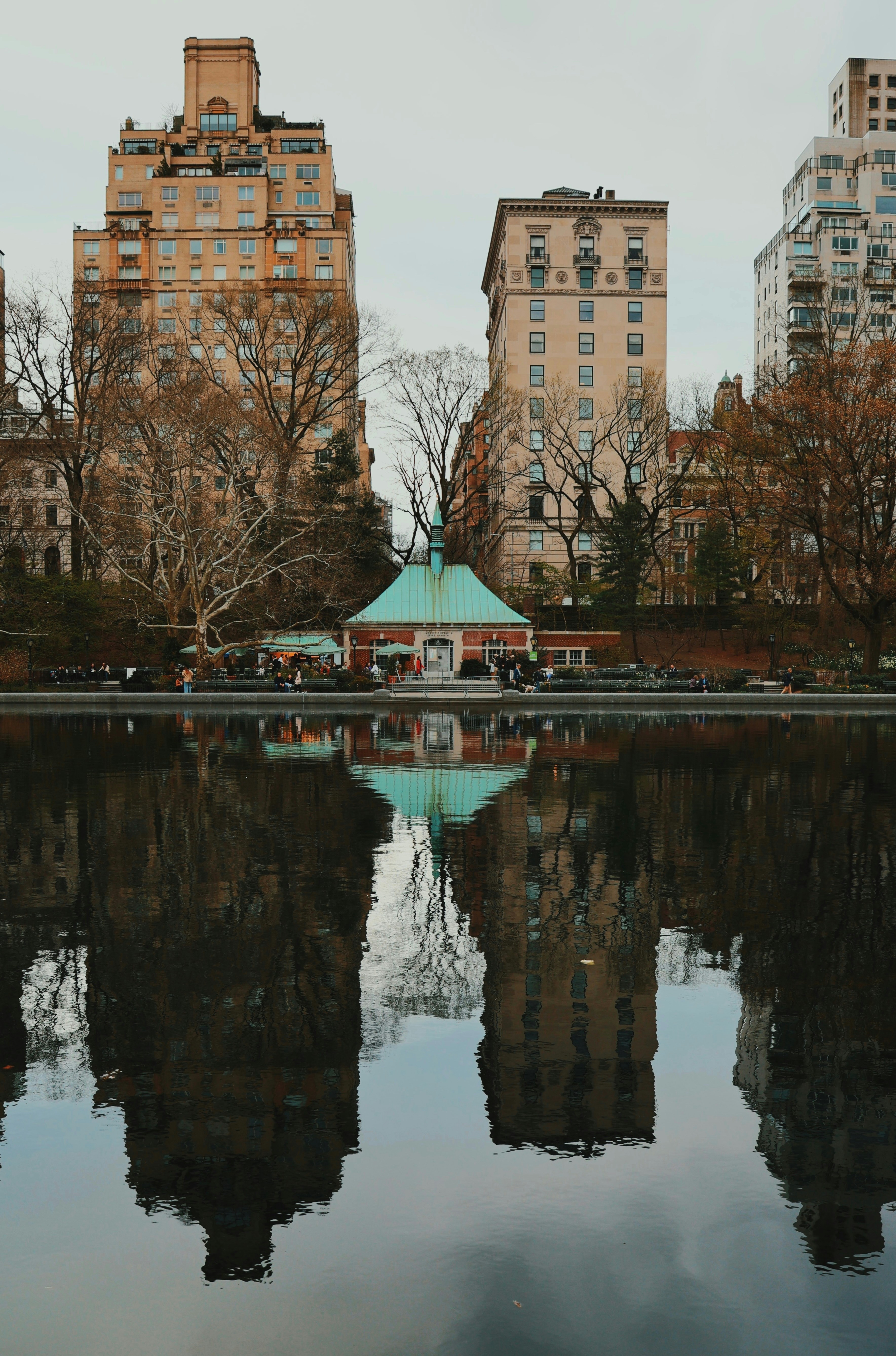 Buildings reflected in a calm body of water.