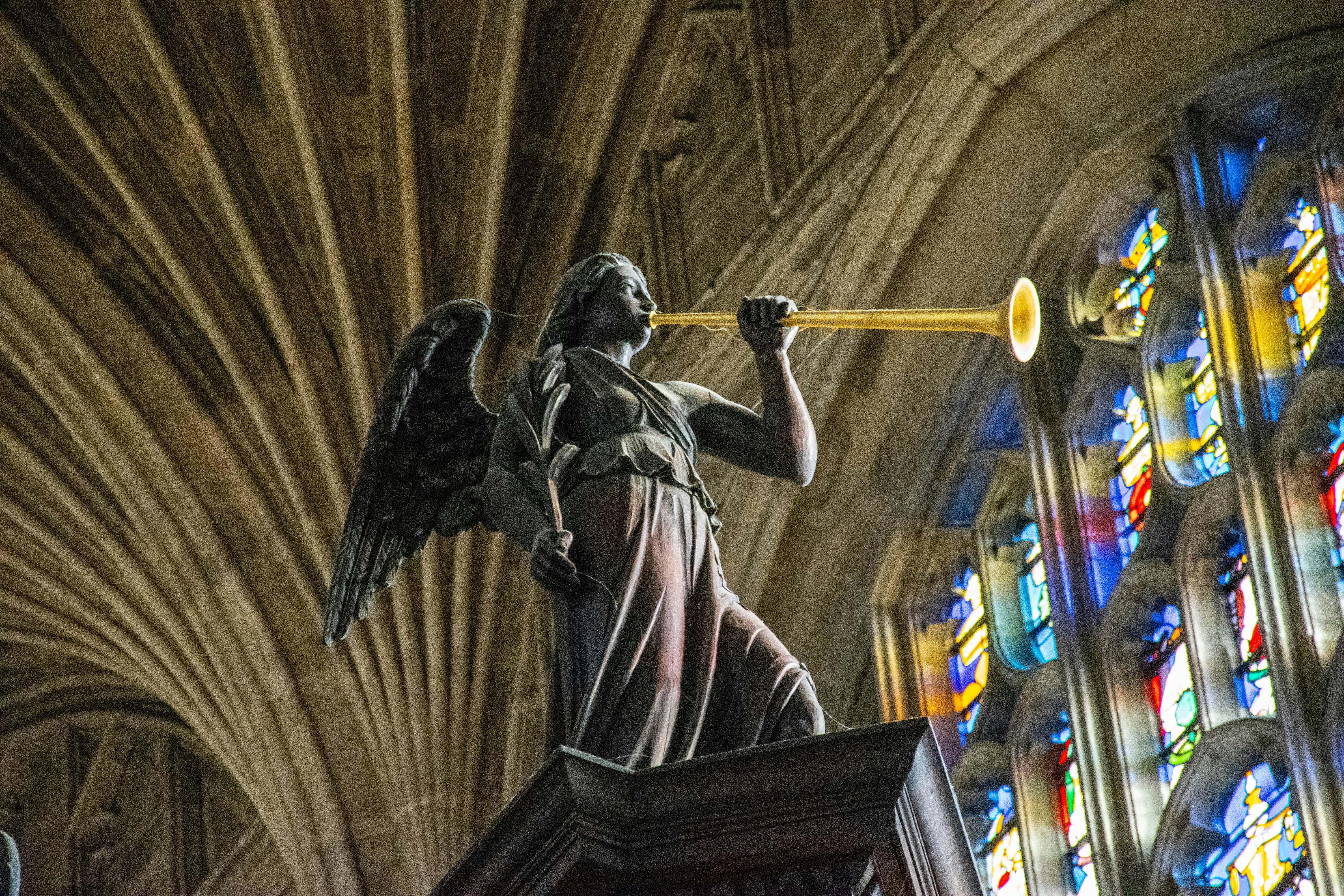 Angel statue blowing a trumpet in a cathedral