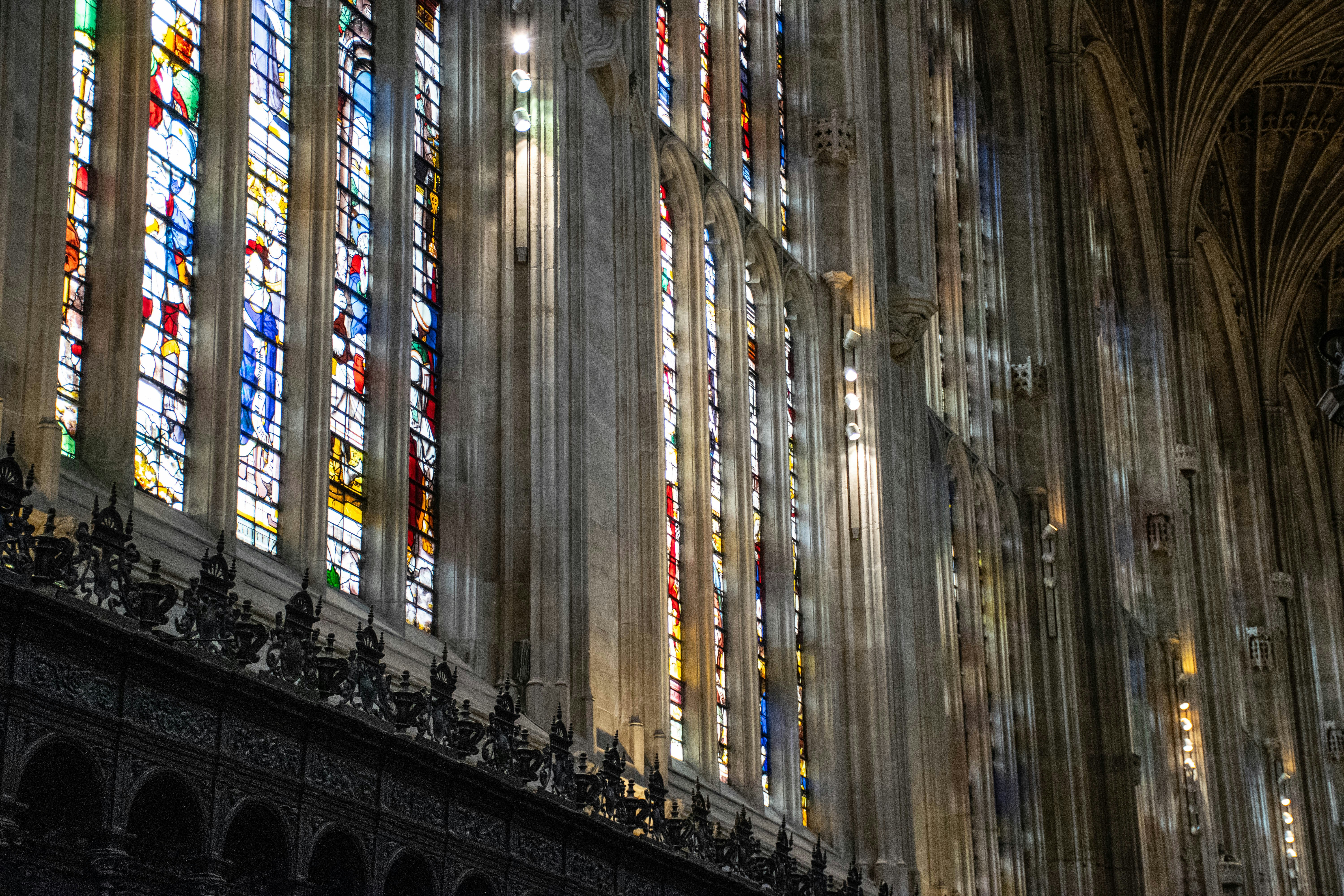 Sunlight streaming through stained glass windows in a church.