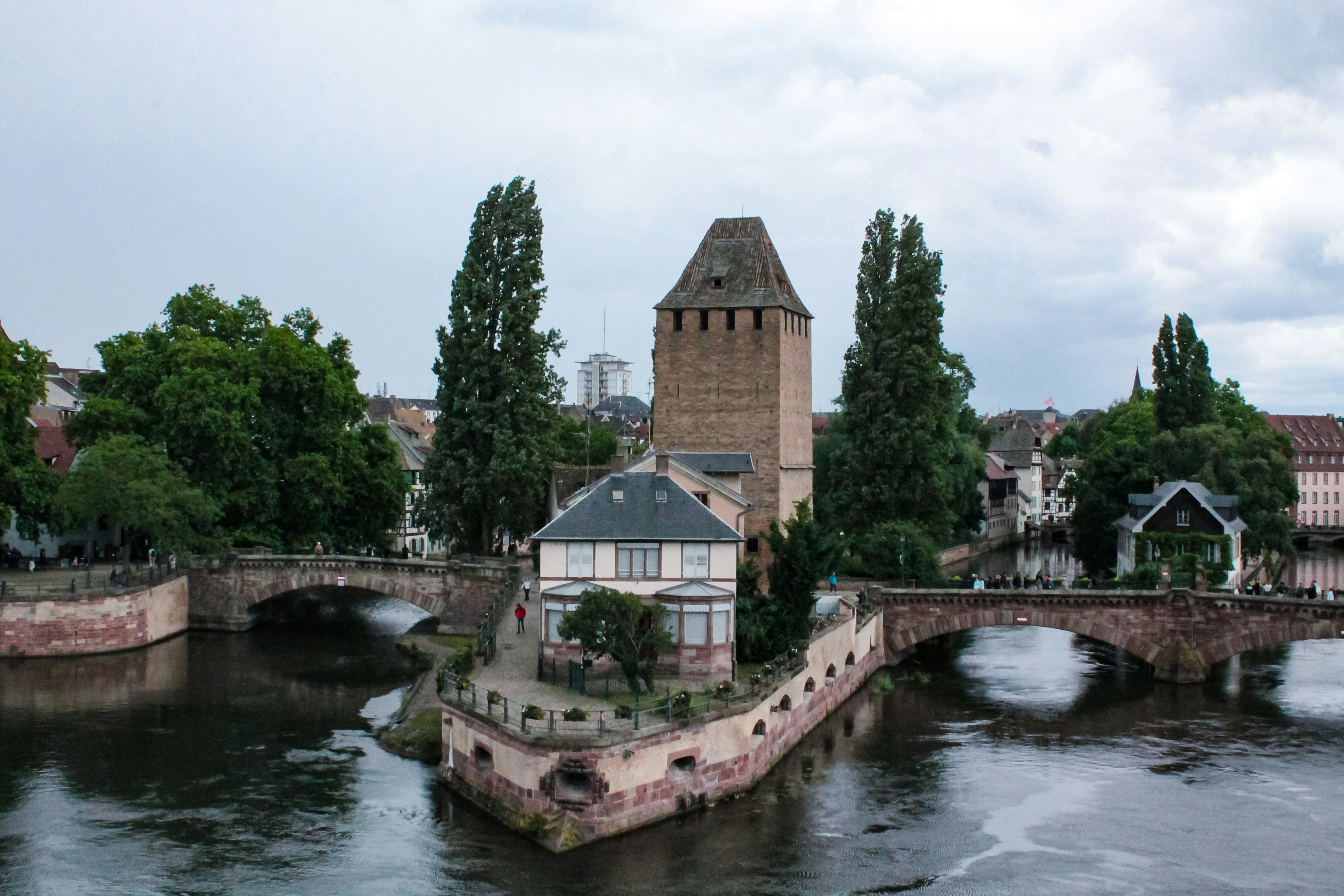 Historic tower and buildings on a river island.