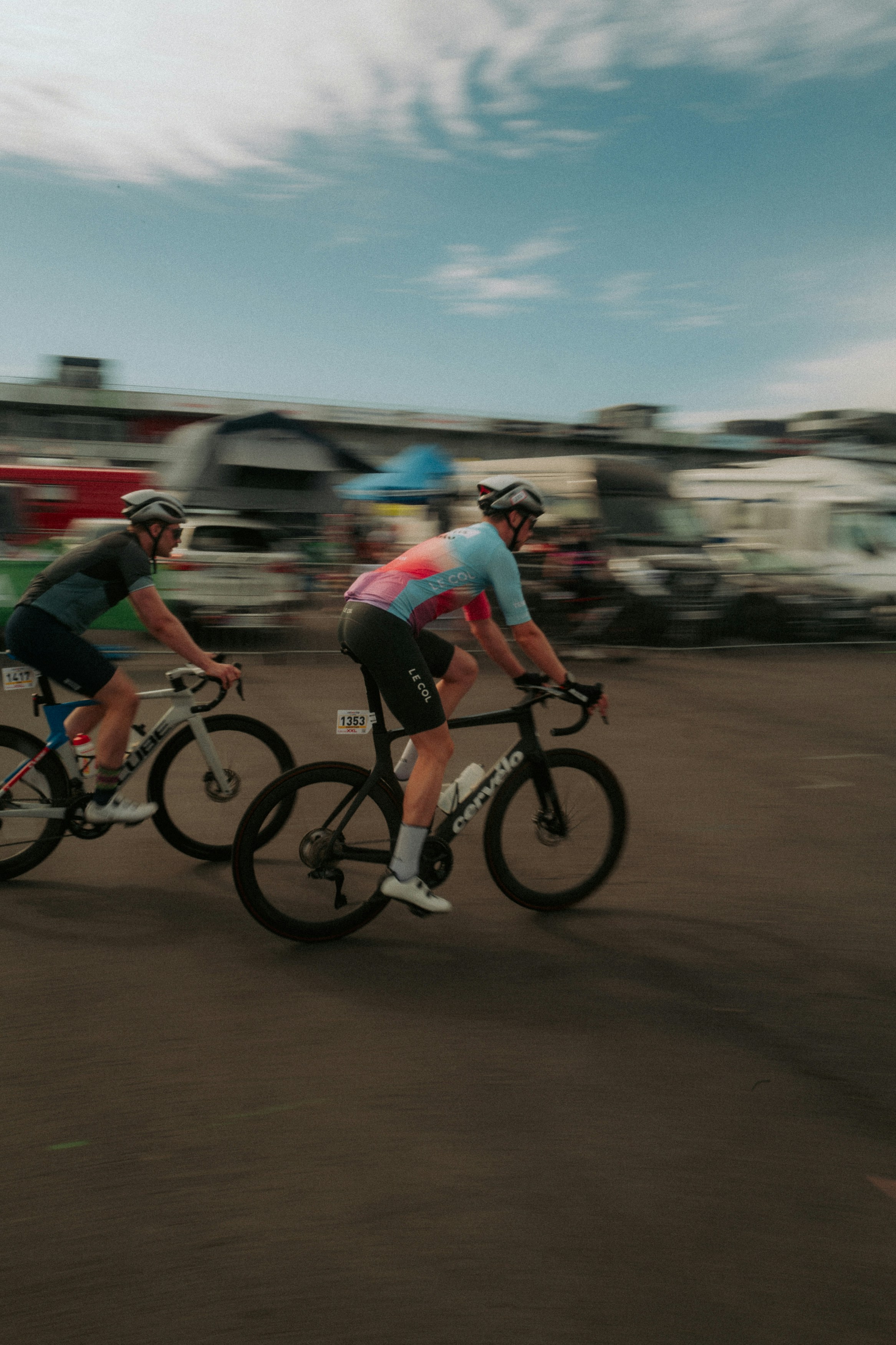 Two cyclists racing on a road with motion blur