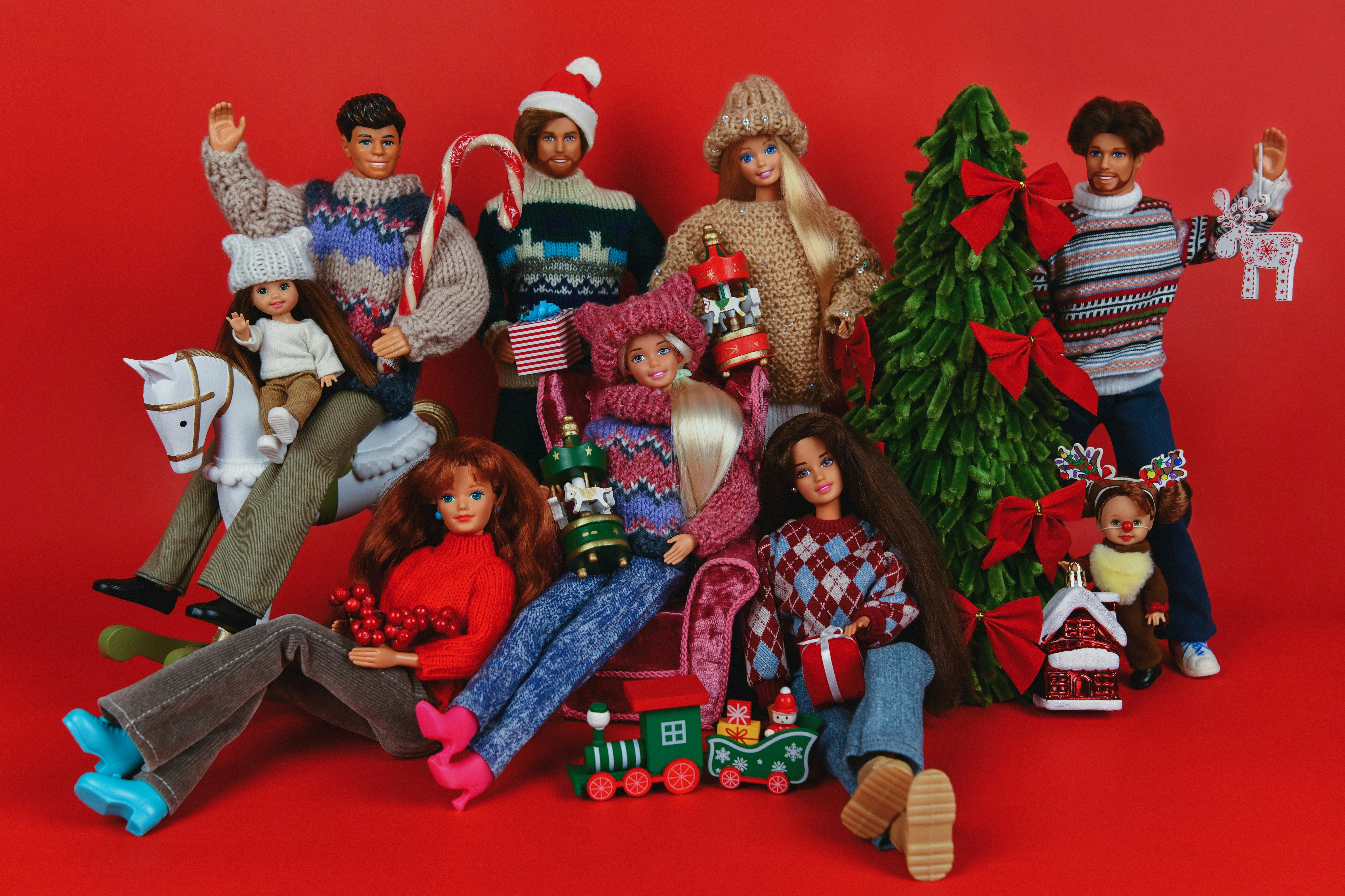 Group of dolls dressed for christmas on red background