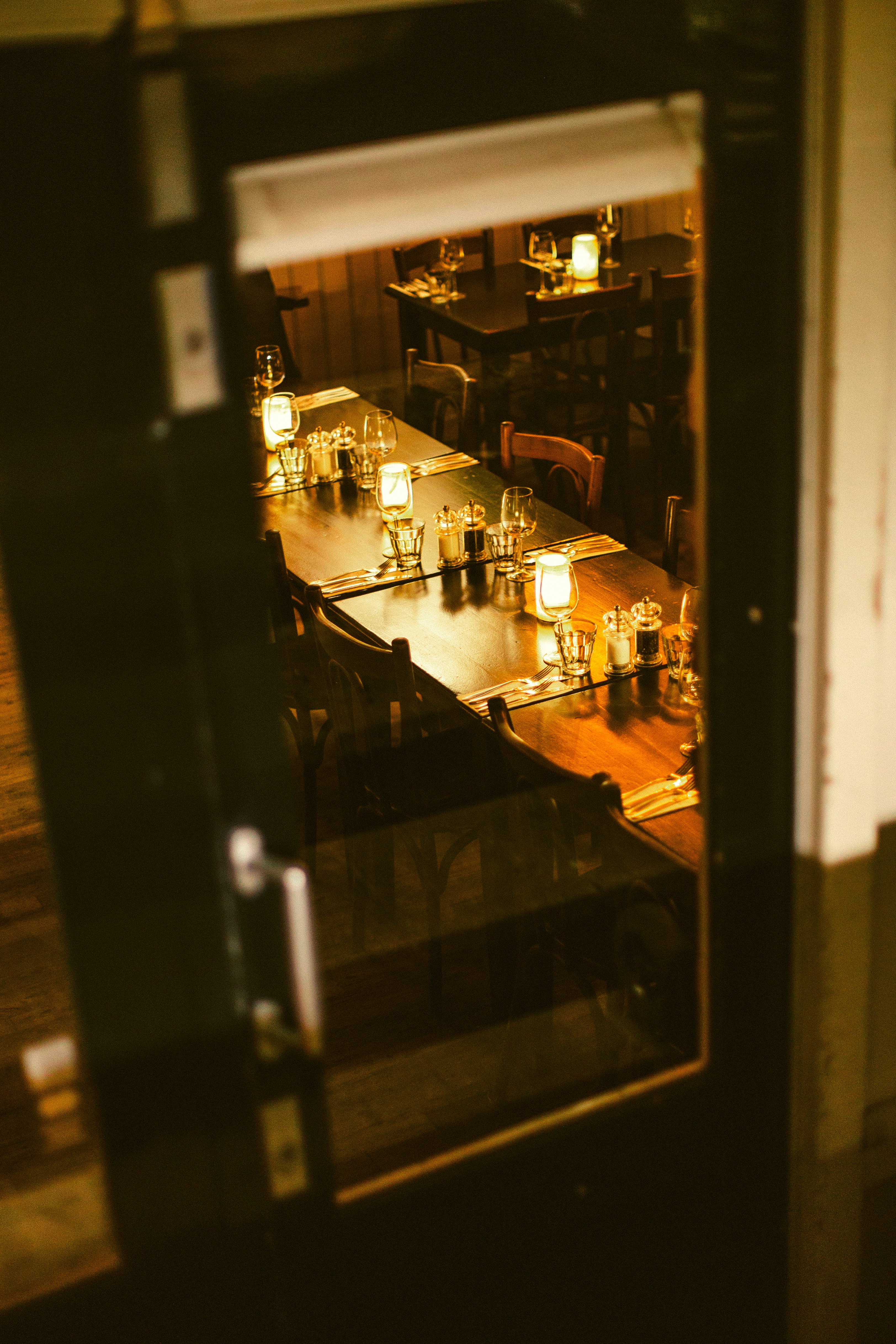 Candlelit dining room prepared for evening service