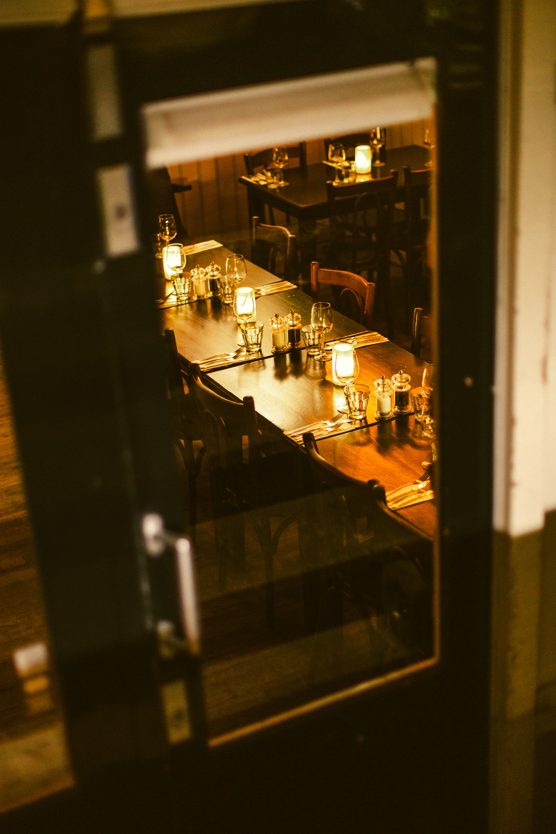 Intimate candlelit restaurant prepared for evening service