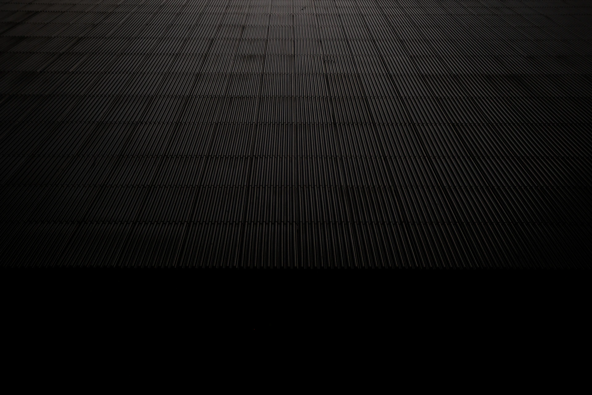 Dark textured surface receding into darkness