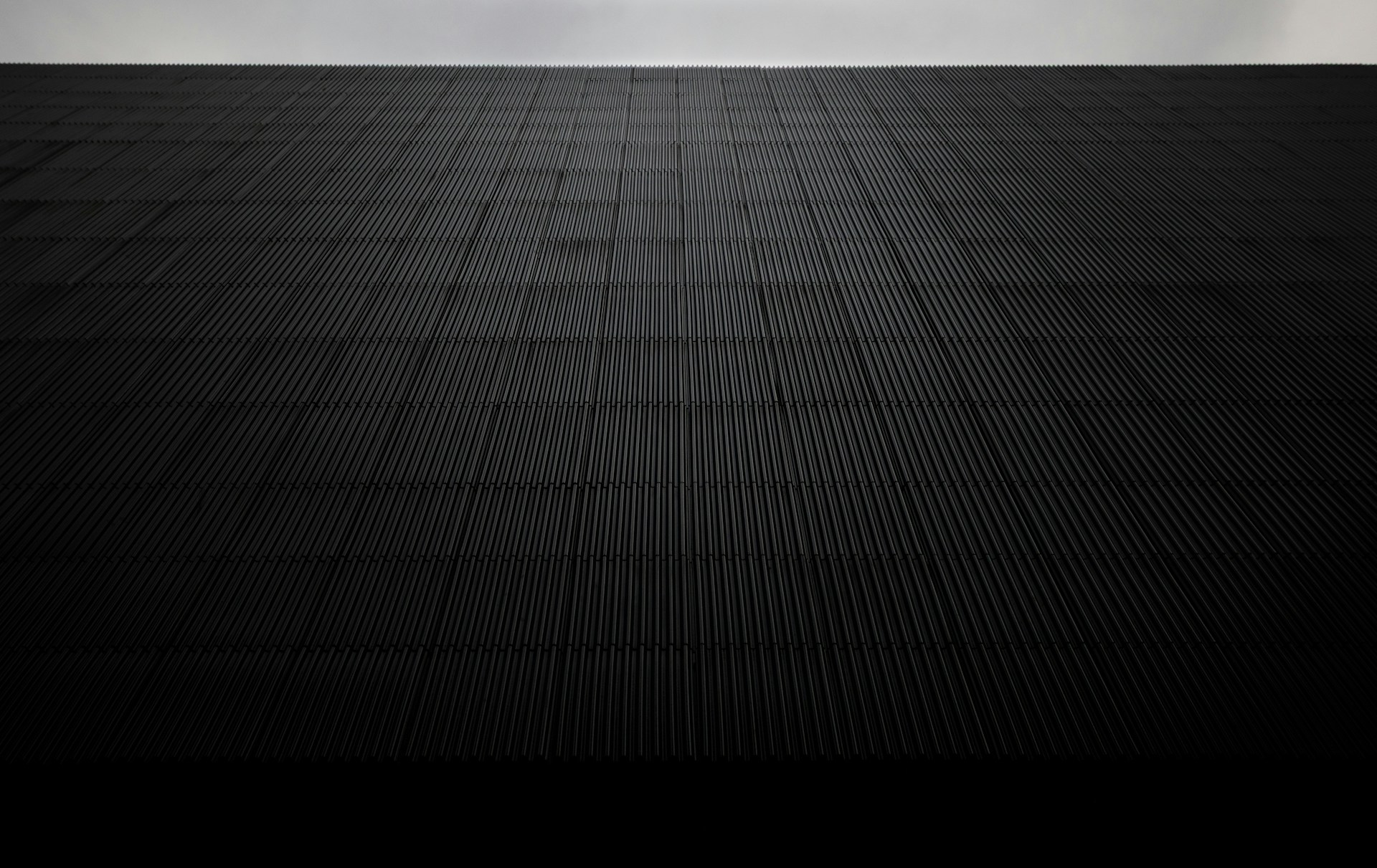 Dark textured wall receding into the distance