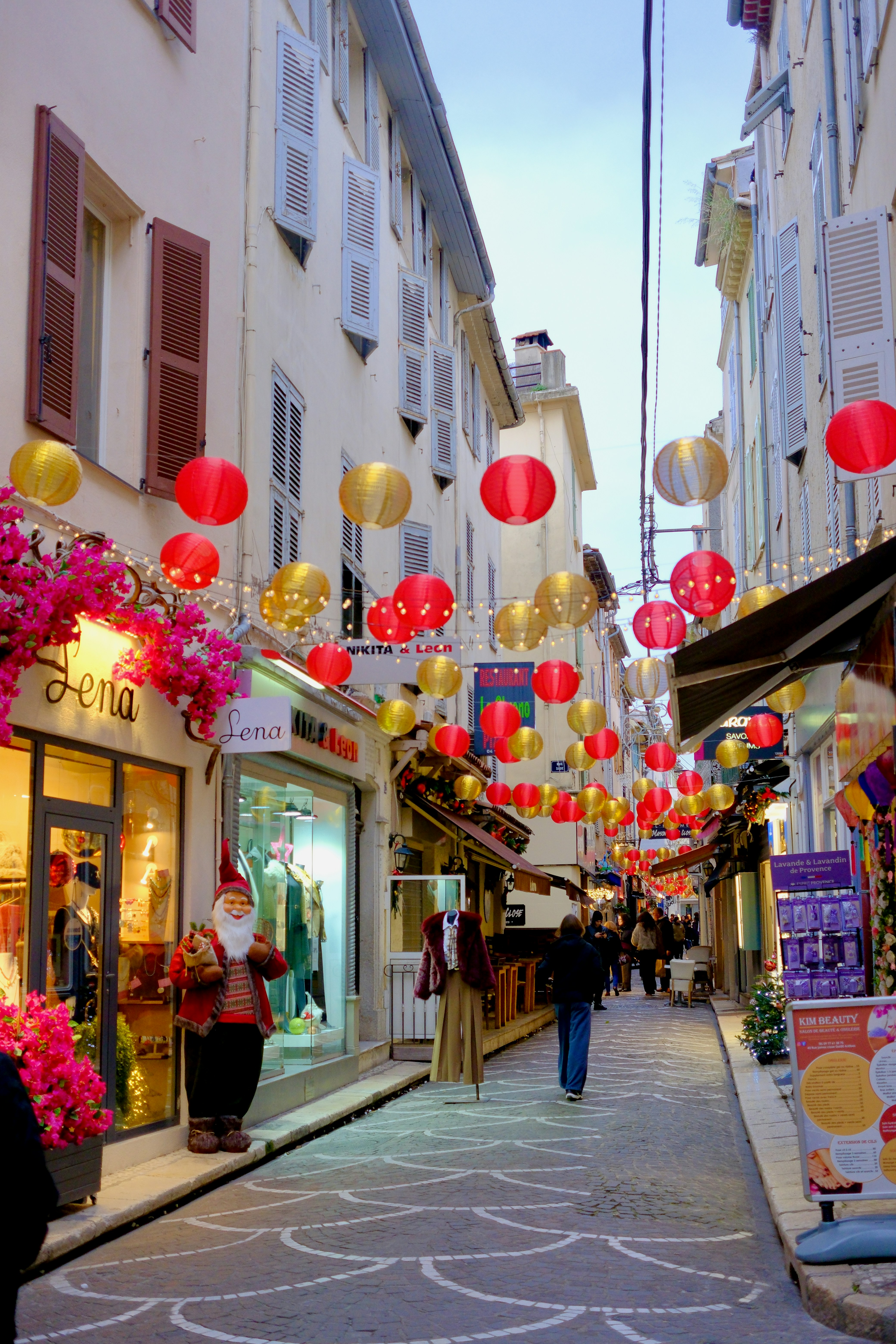 Street decorated with red and gold lanterns for celebration.
