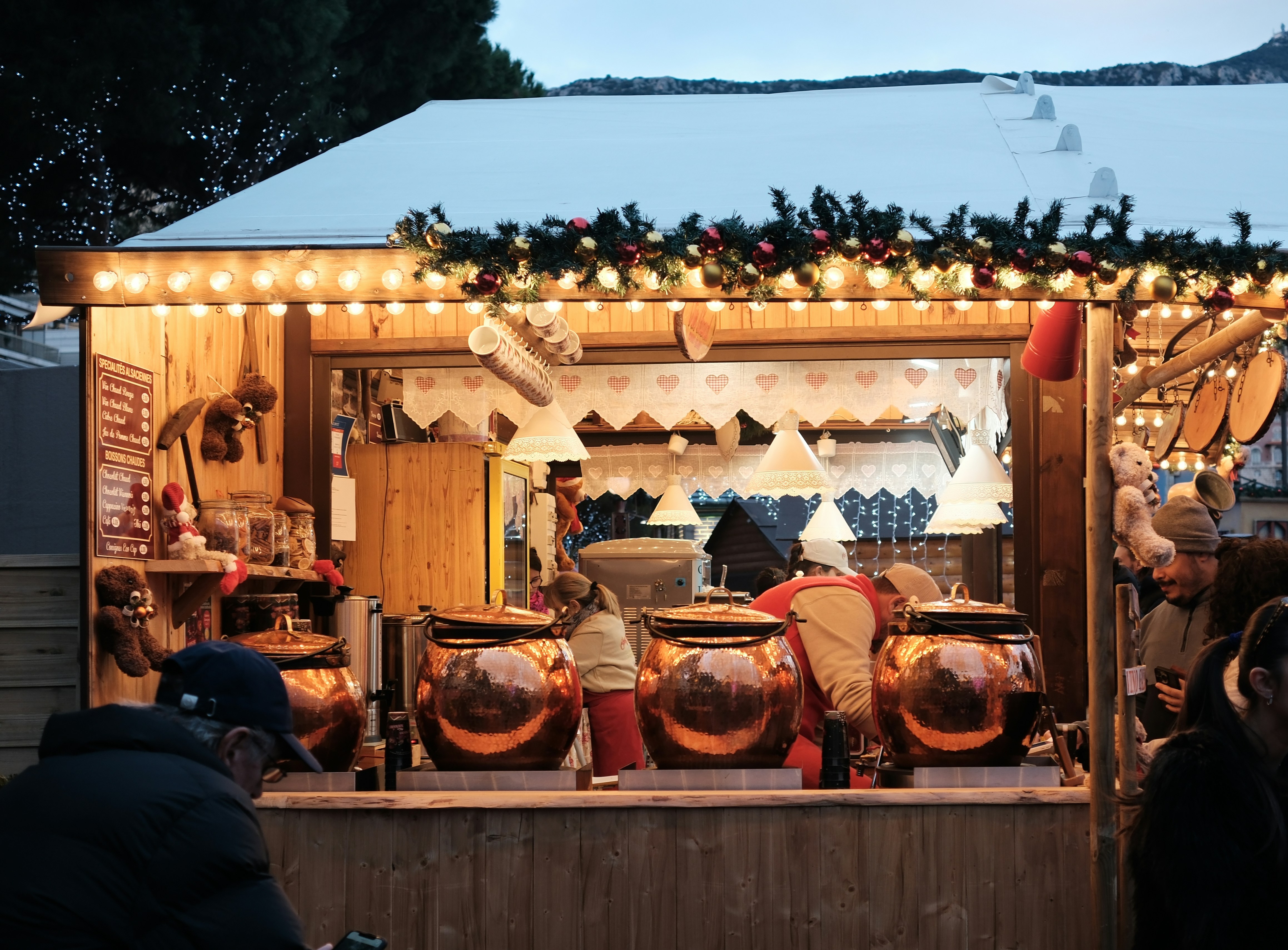 A cozy christmas market stall with warm lights