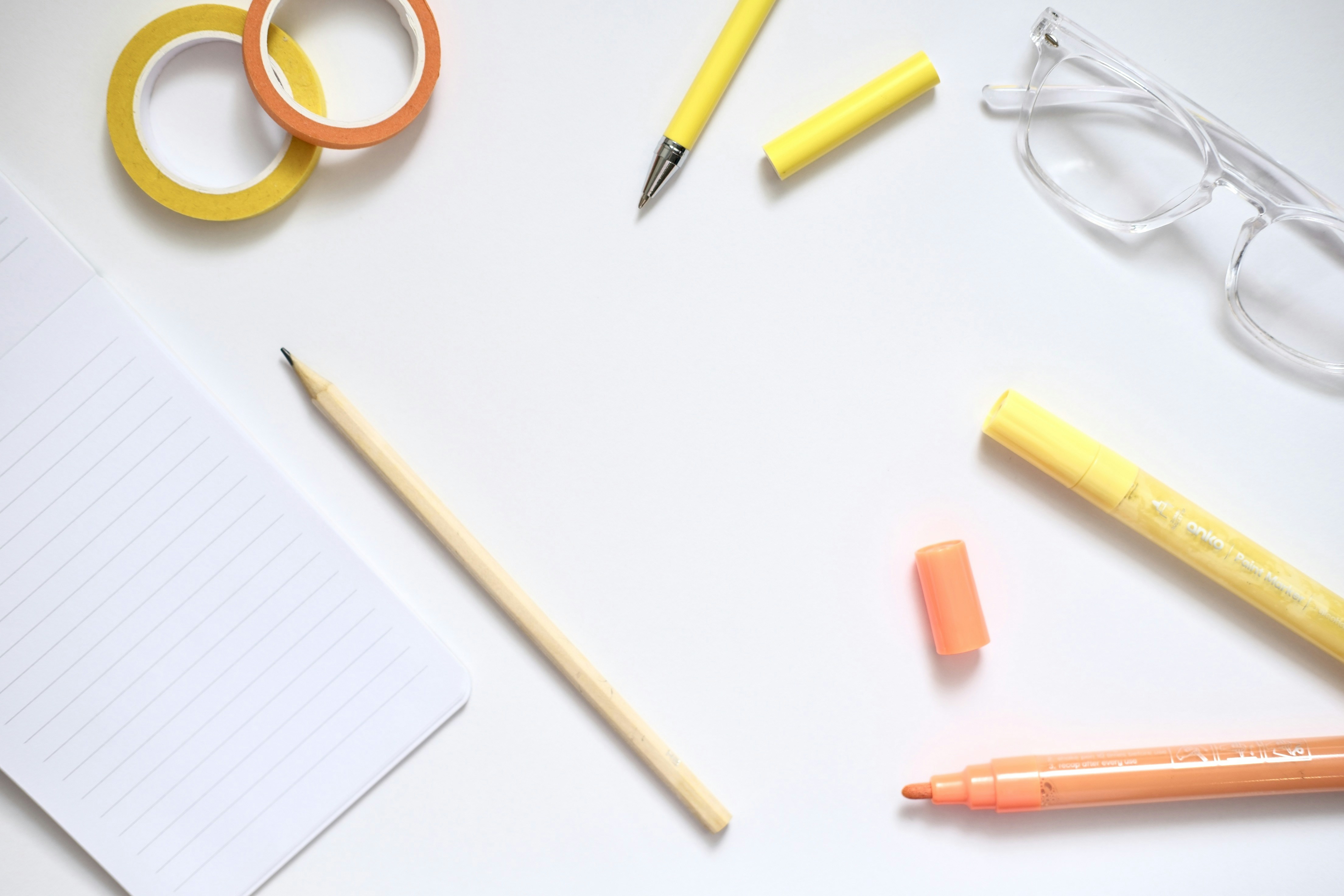 Desk supplies including pens, markers, and glasses