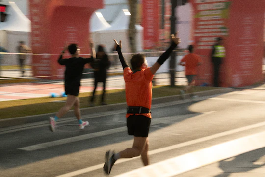 Runner celebrating crossing the finish line at a marathon.