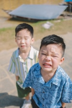 Two young boys with a bandage on one's forehead