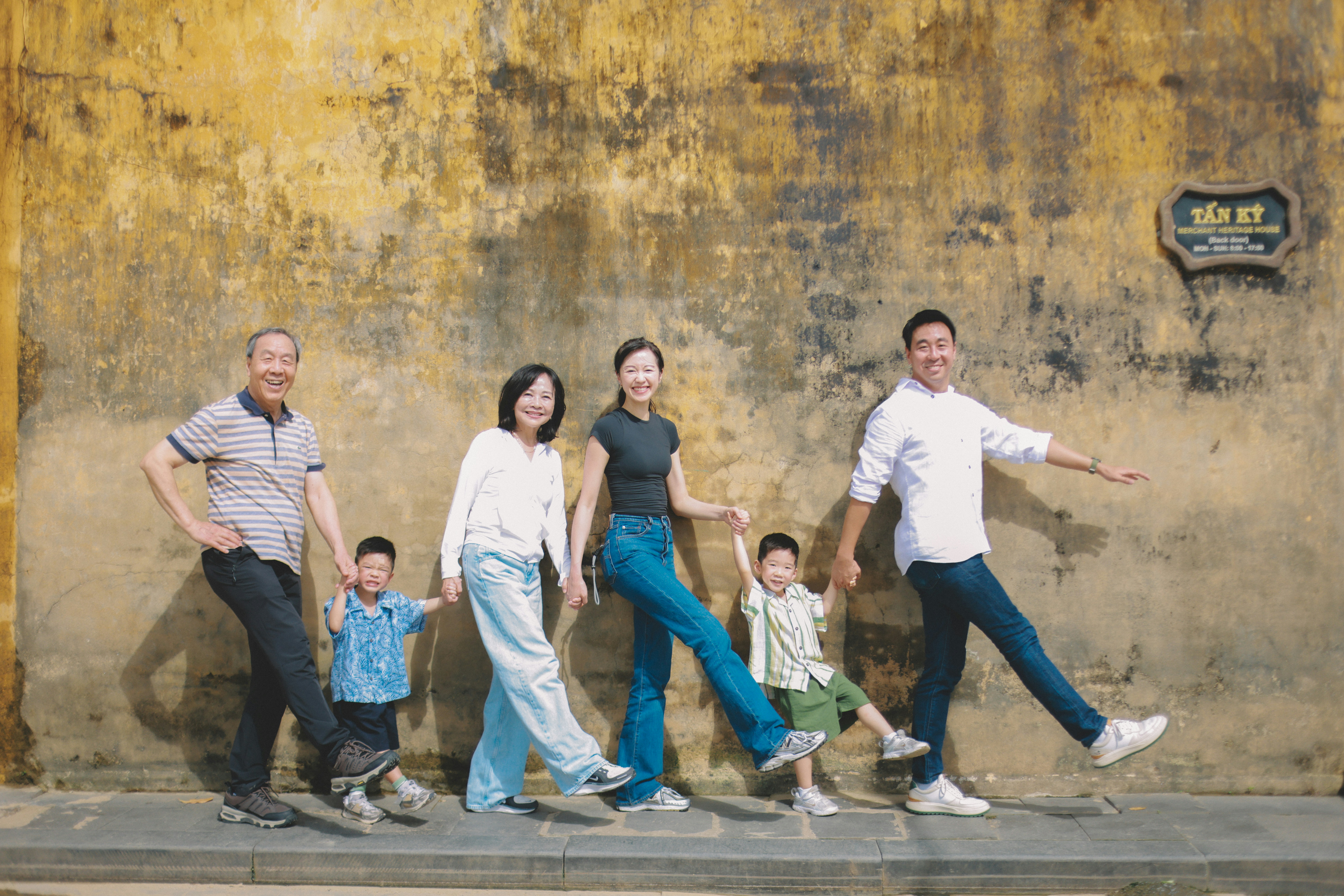 Family walking together in front of textured wall