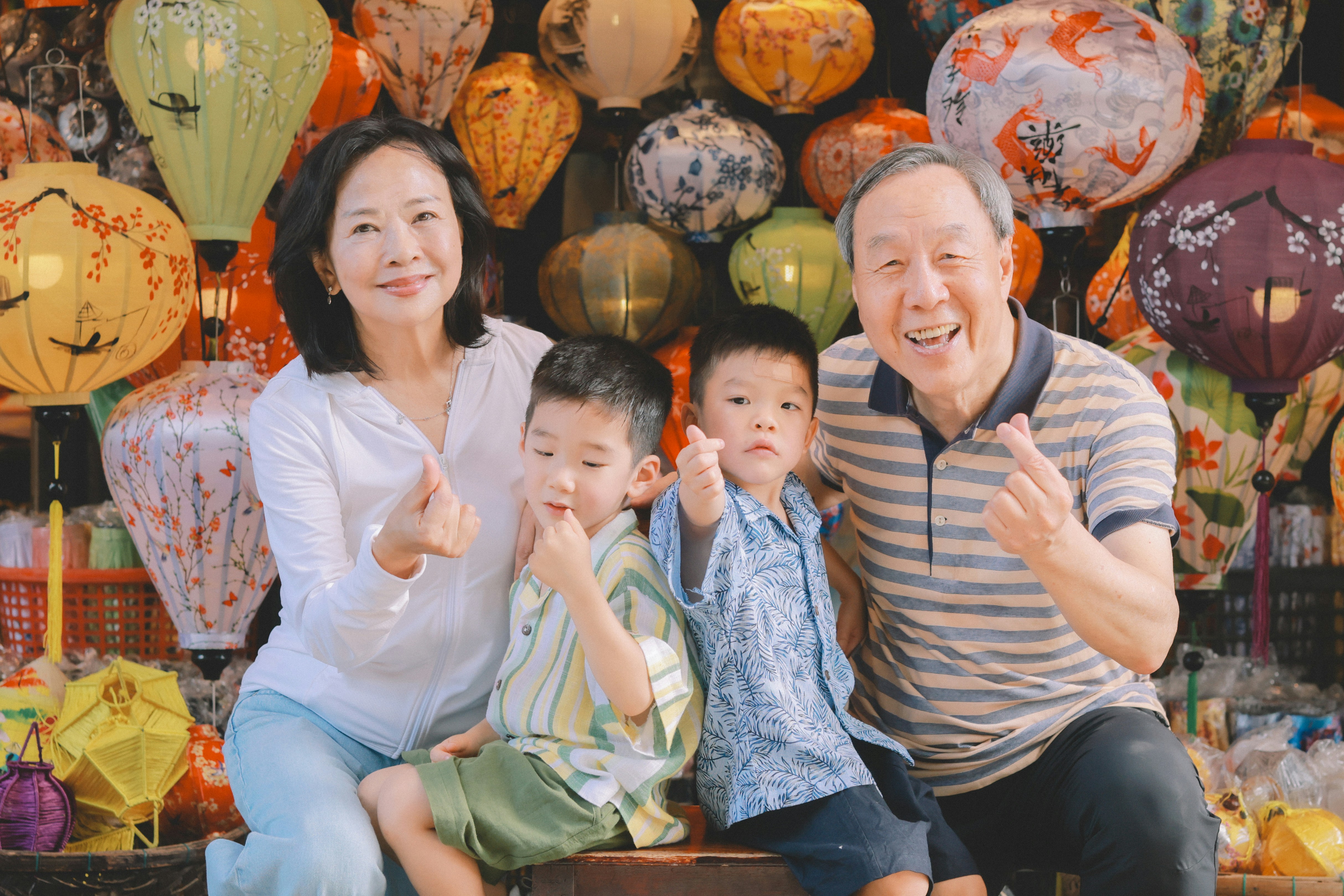 Family posing with colorful lanterns in the background