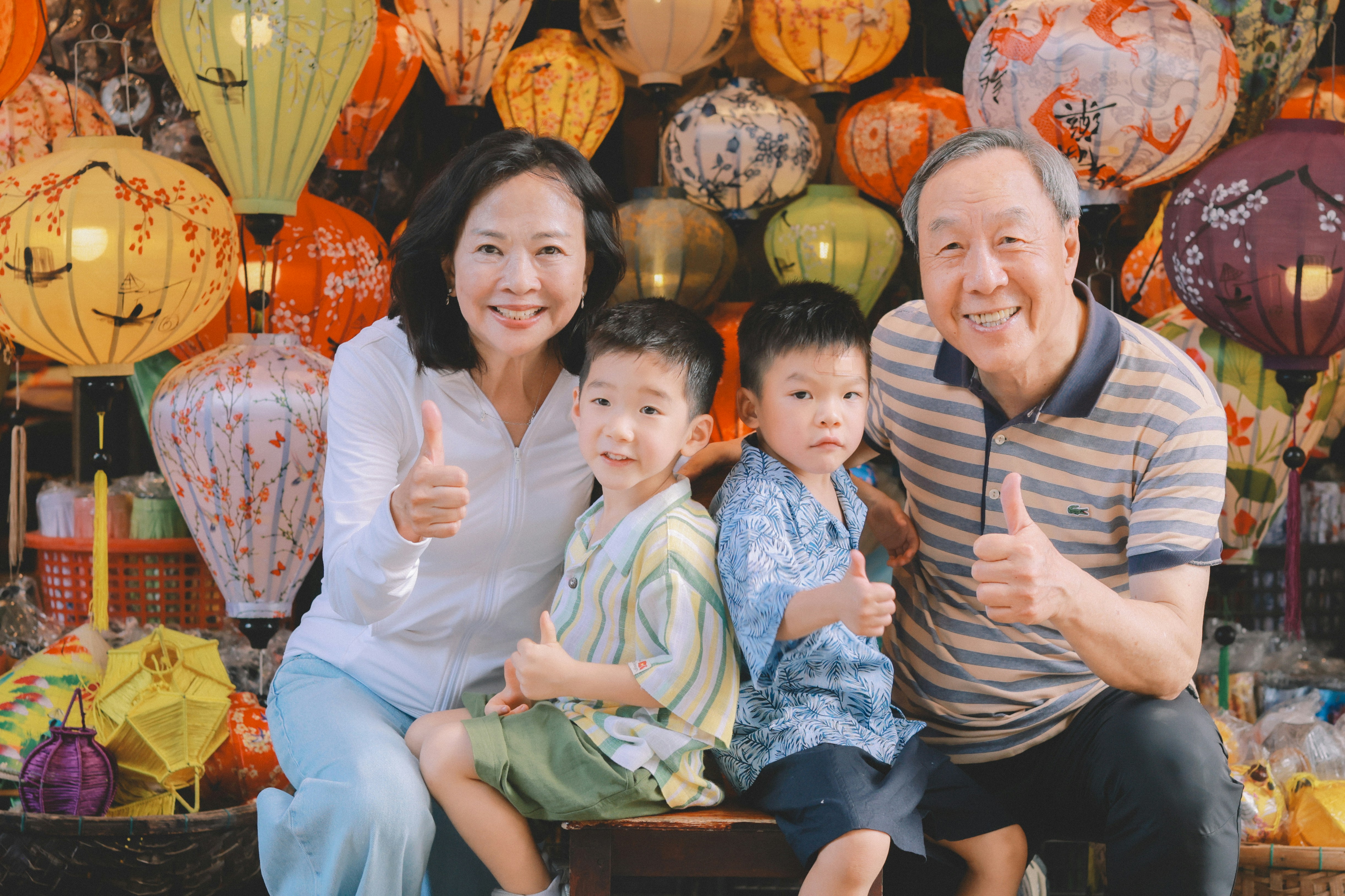 Family poses in front of colorful lanterns