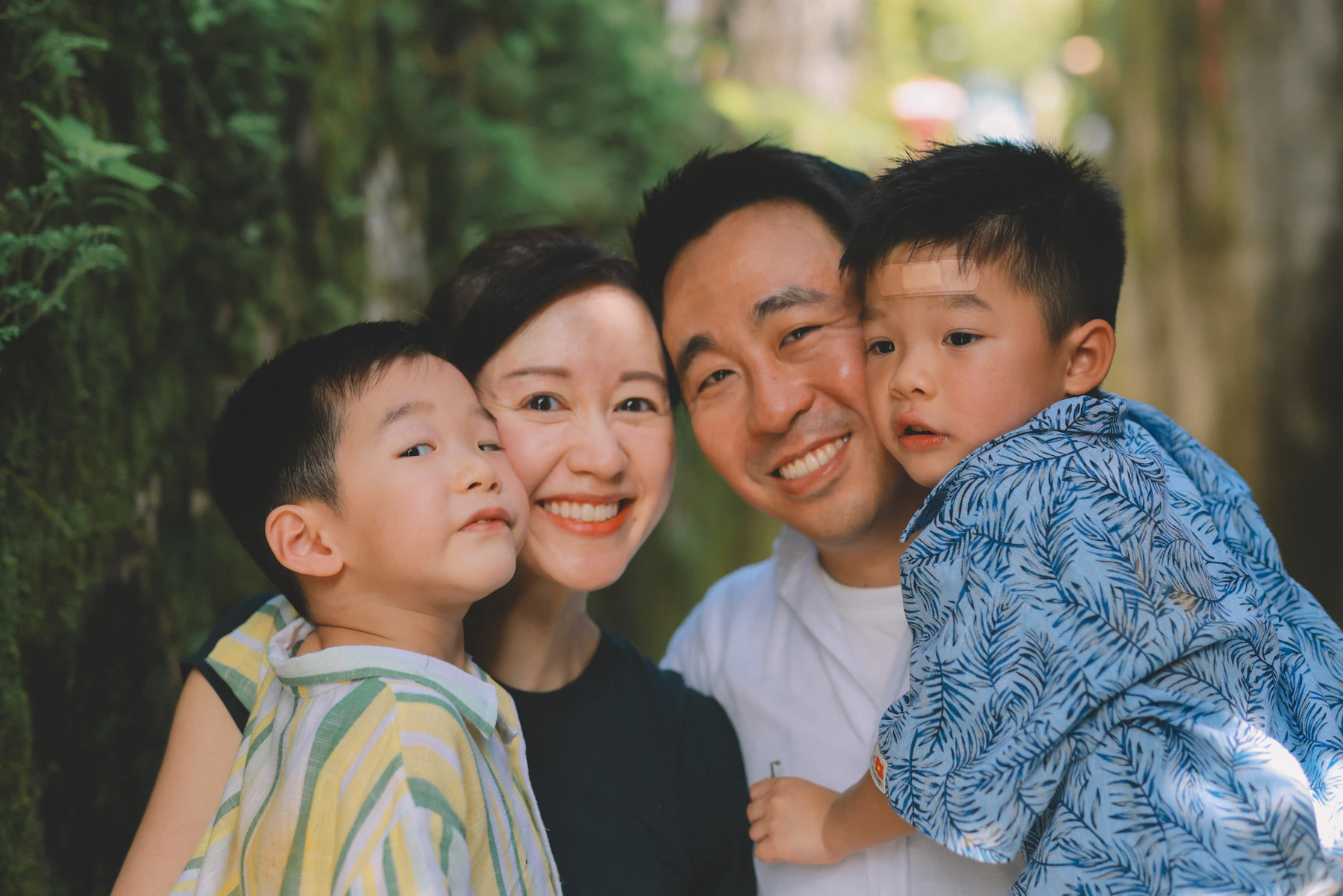 An Asian family of four together outdoors