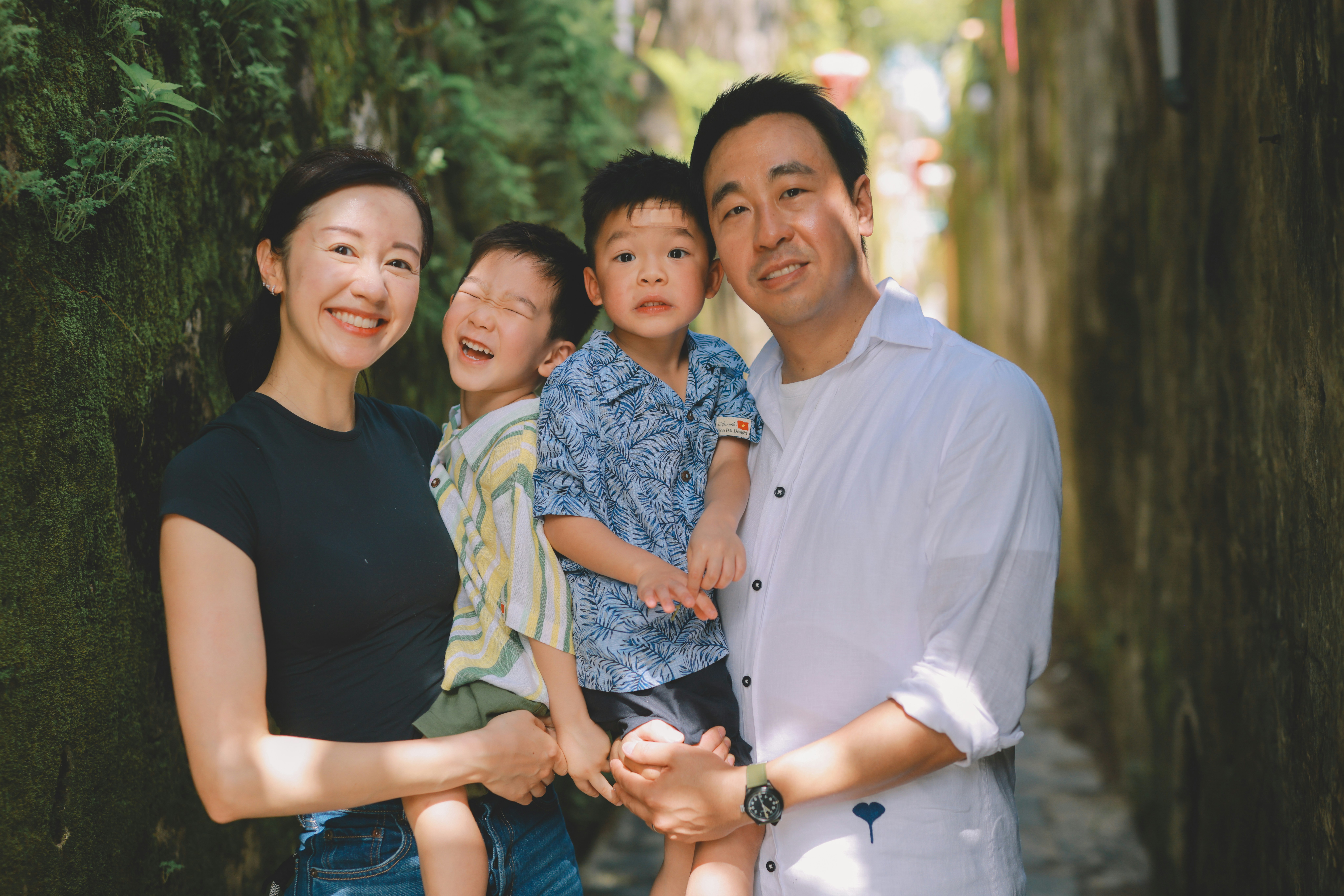 A happy family of four posing for a portrait