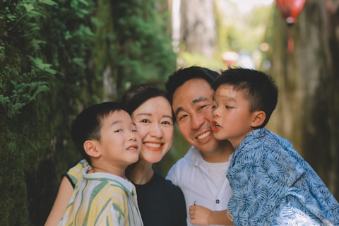 A happy family posing for a portrait outdoors.