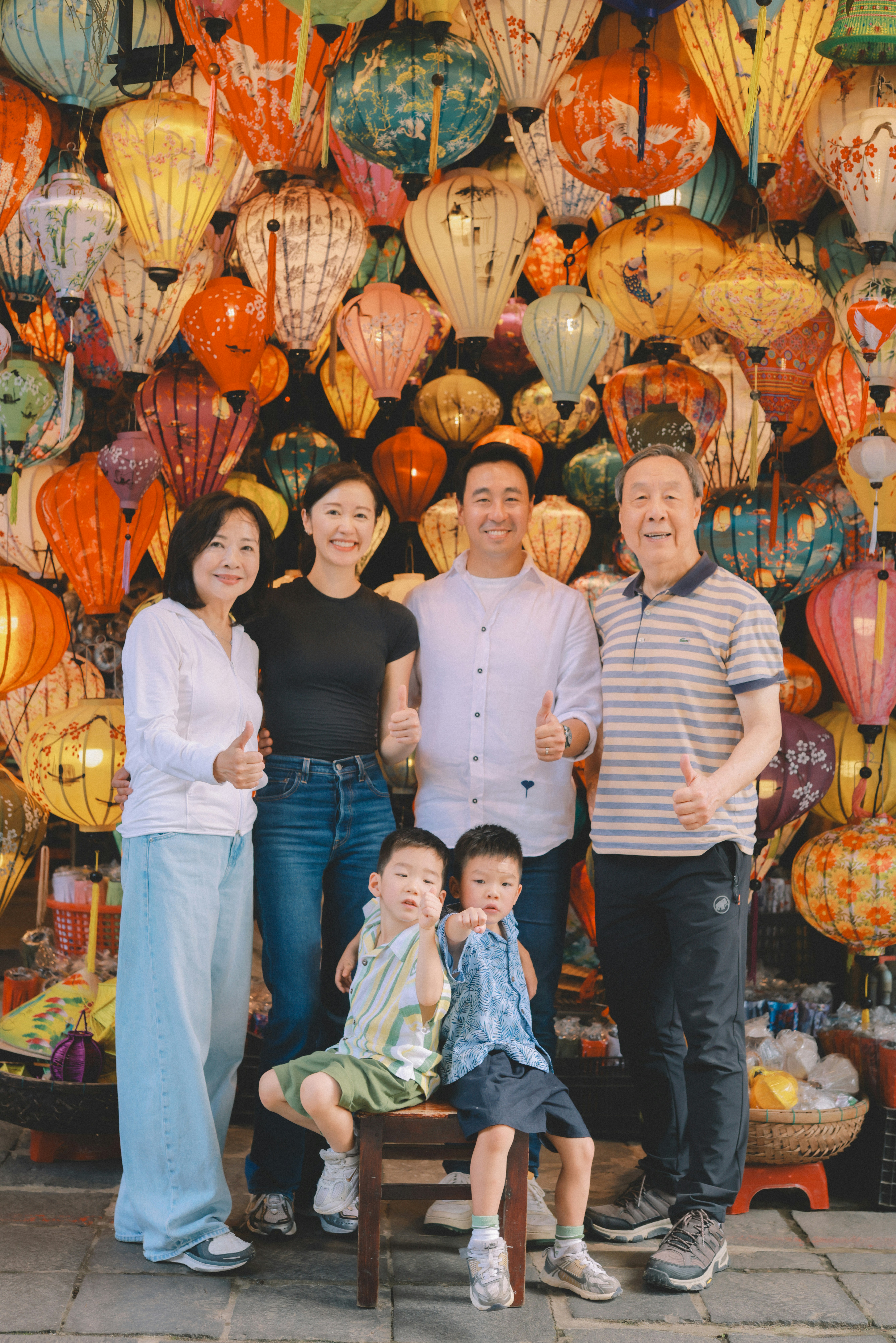 Family posing in front of colorful lanterns