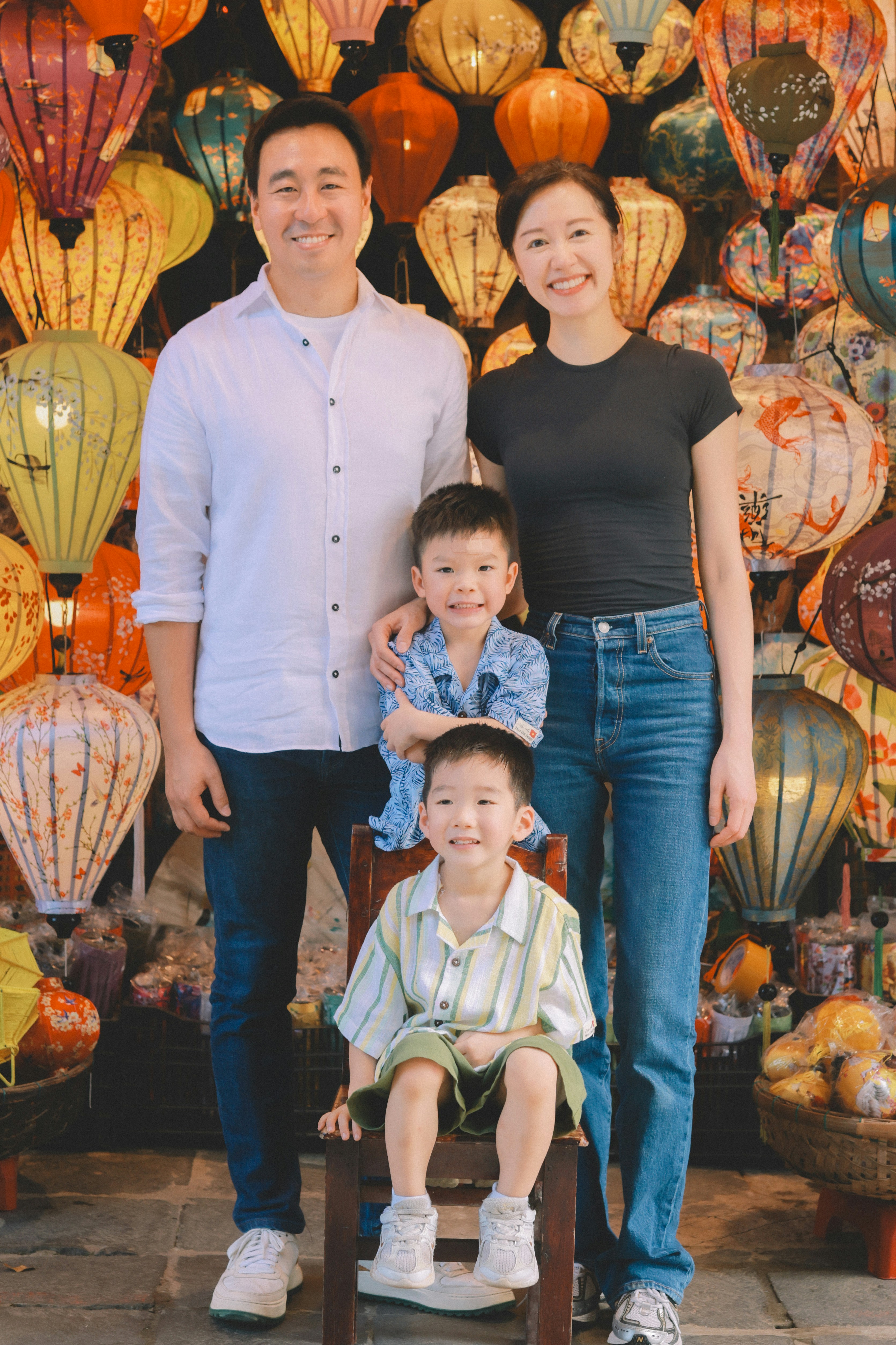 Family poses in front of colorful lanterns