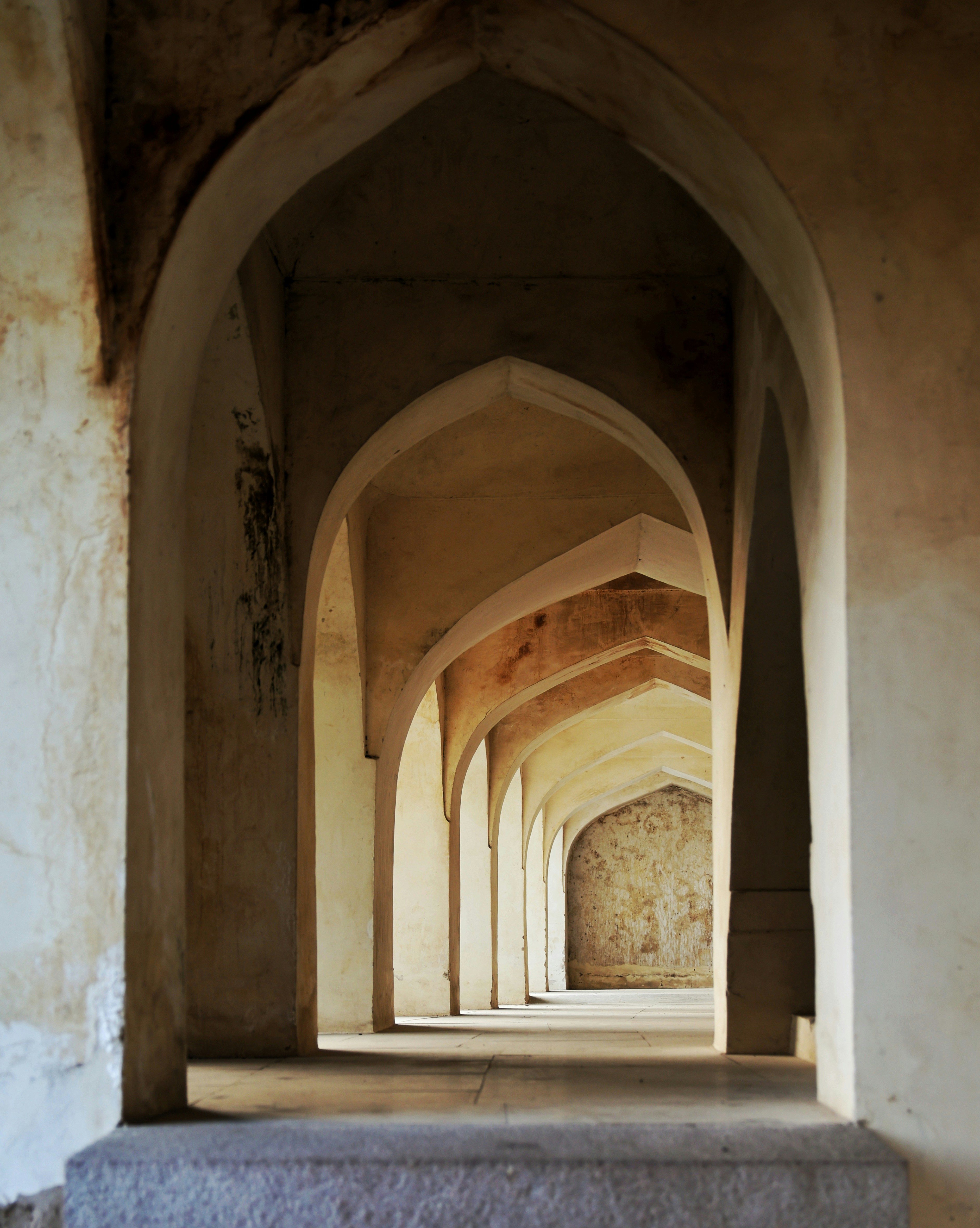 Arches receding into the distance in an old building