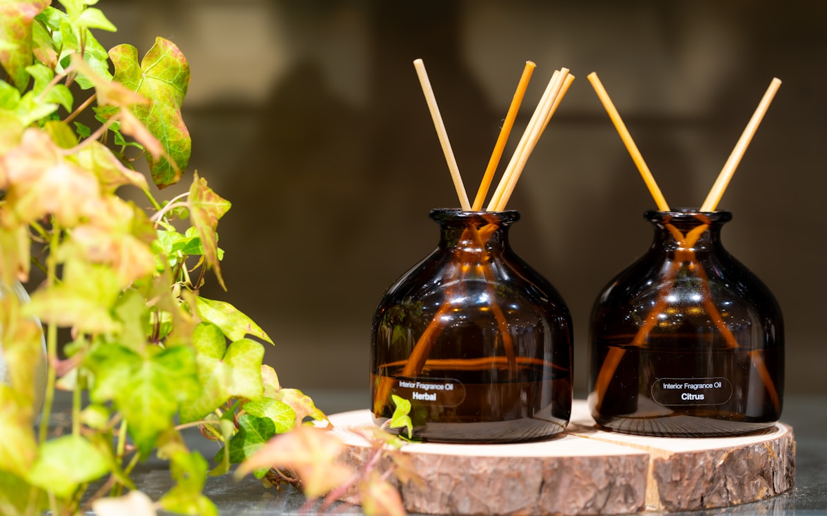 two-amber-glass-reed-diffusers-with-wooden-reeds-UZT7ZPxbPMM collection background image