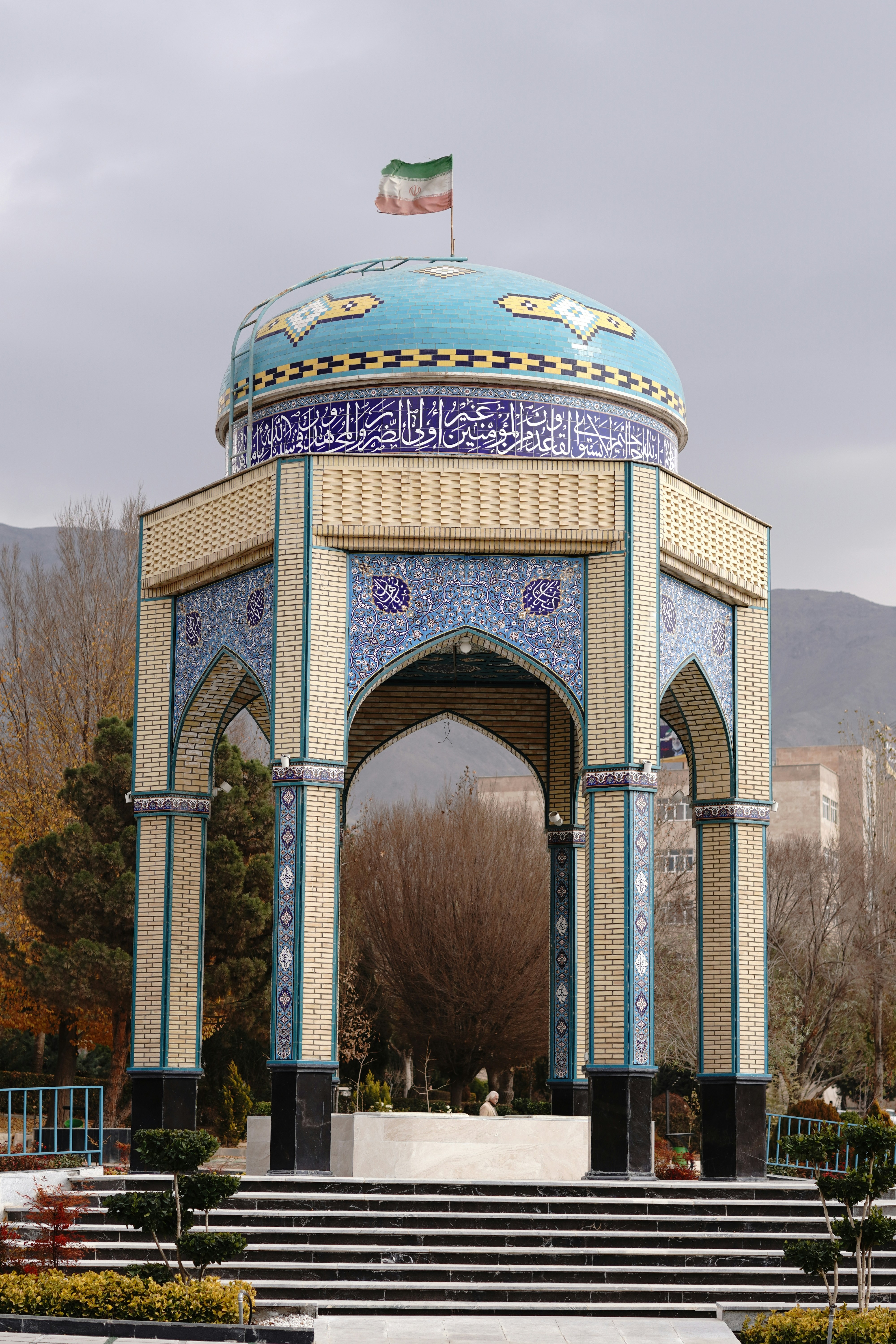 Ornate pavilion with blue tiled dome and arches