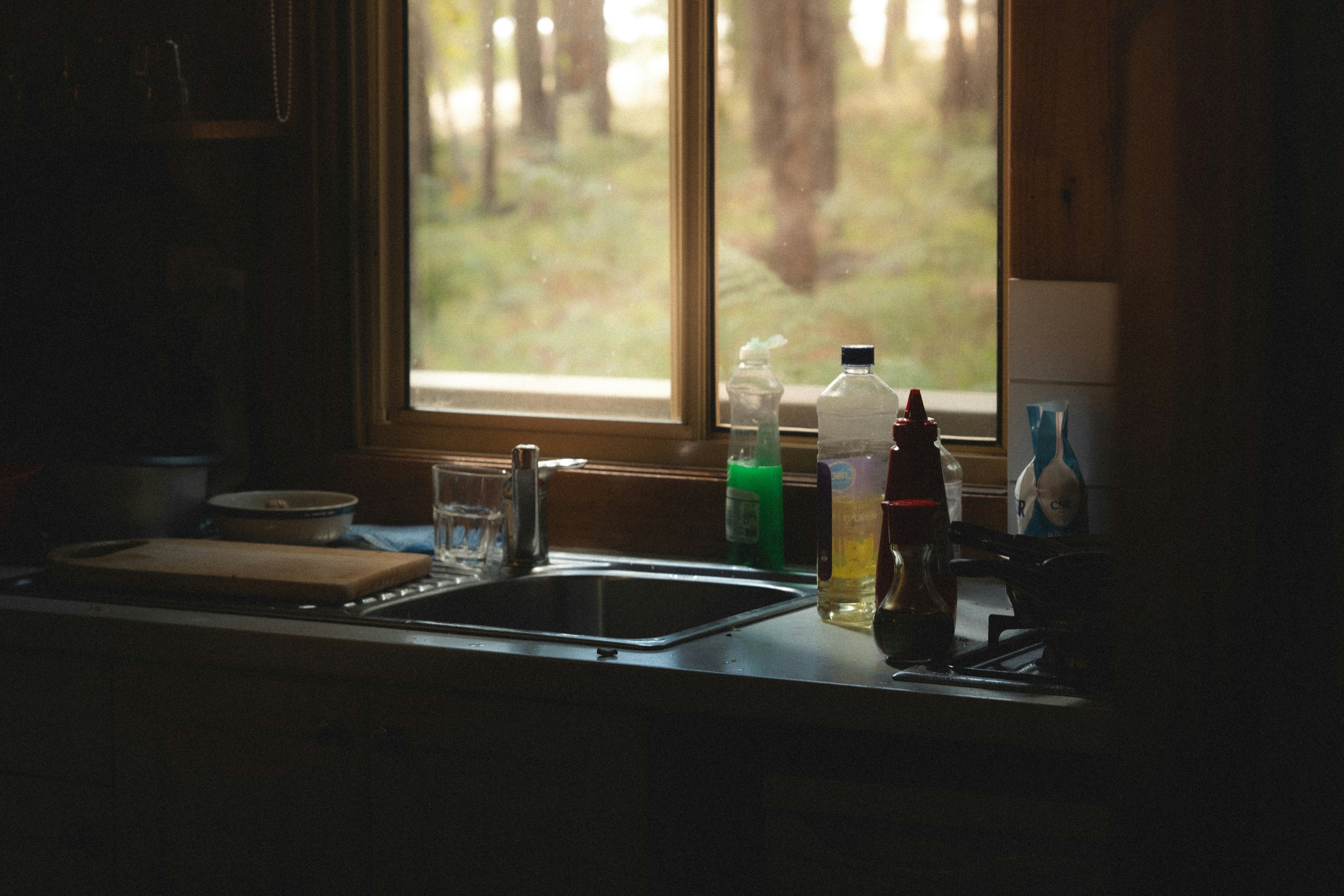 Kitchen sink with baking soda, vinegar, and a plunger for DIY drain maintenance - Salt Lake City residential plumbing