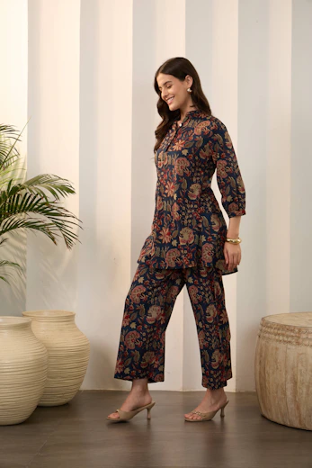 Woman in a floral print navy blue kurta and pants