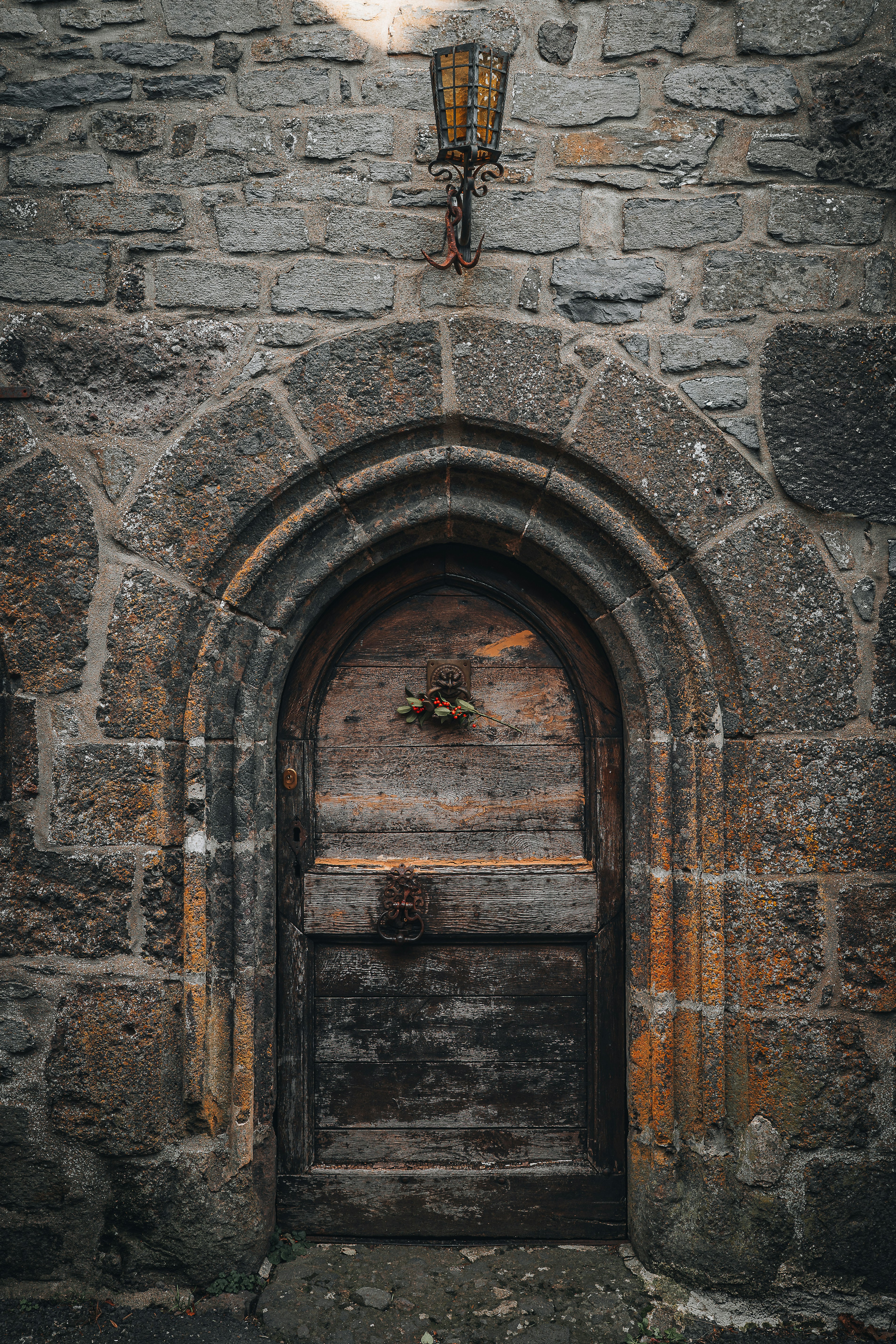 Old wooden door set in a stone archway.
