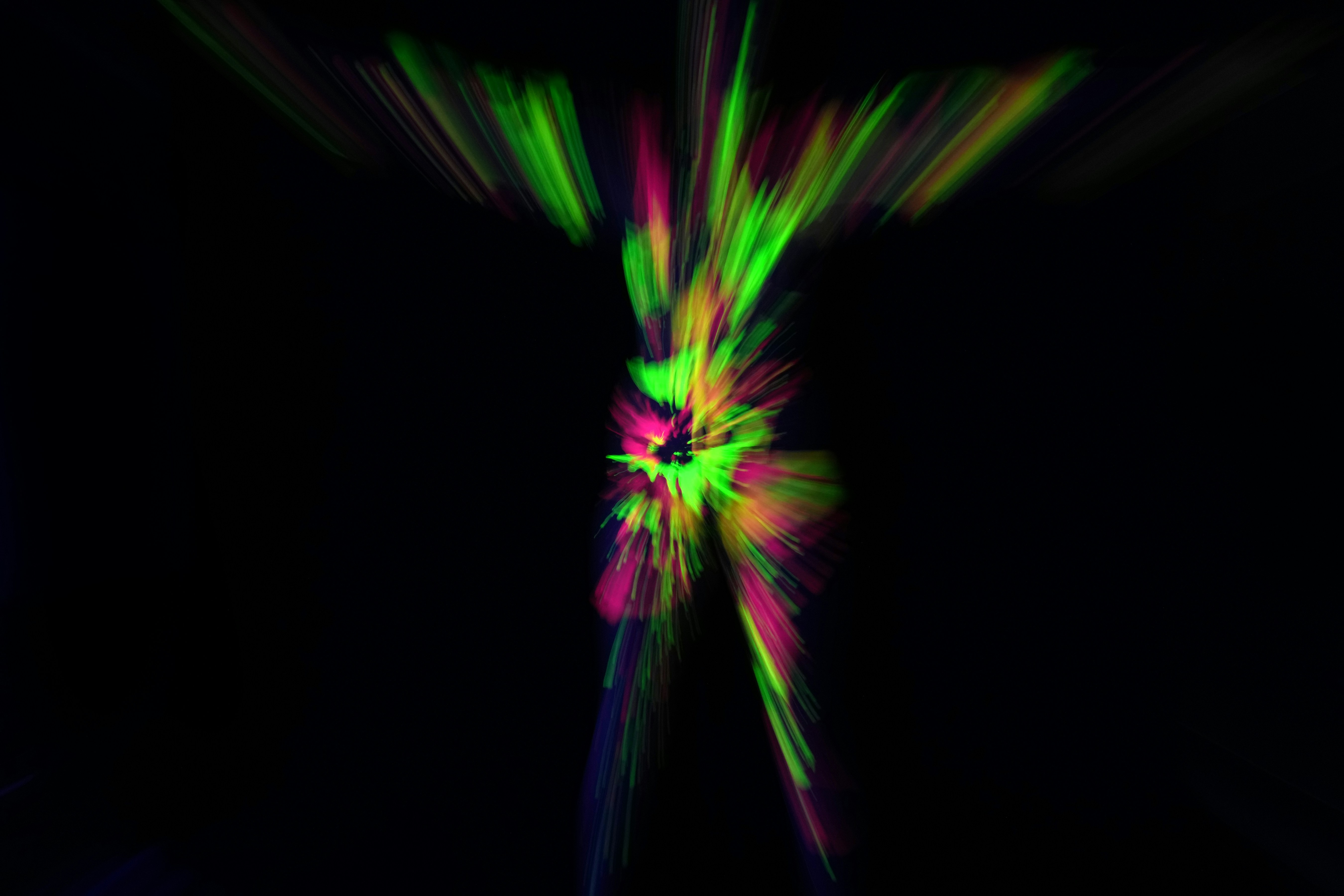 Abstract explosion of colorful light streaks on black background