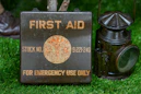 Vintage first aid kit and lantern on grass