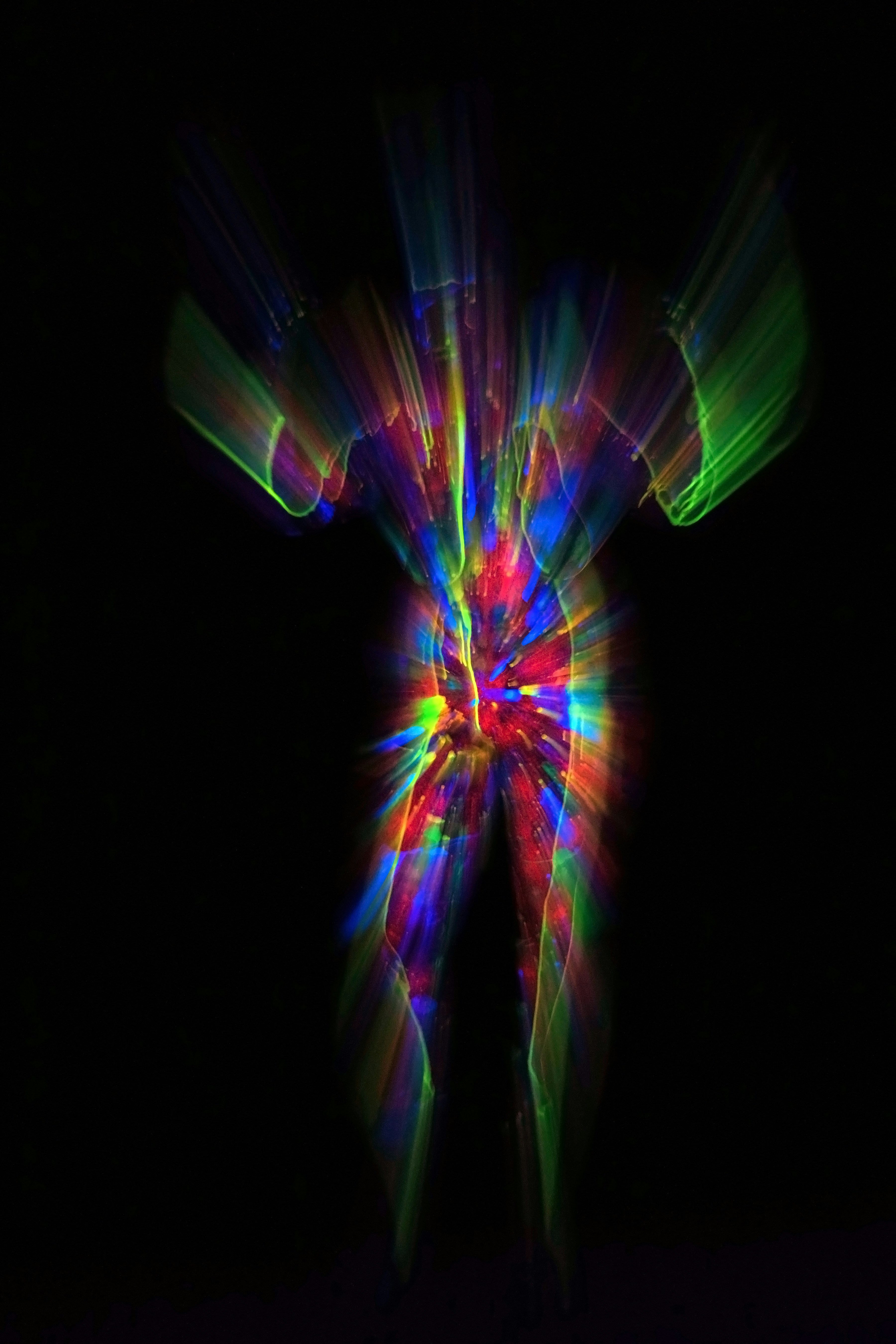 Abstract figure with colorful light streaks on black background