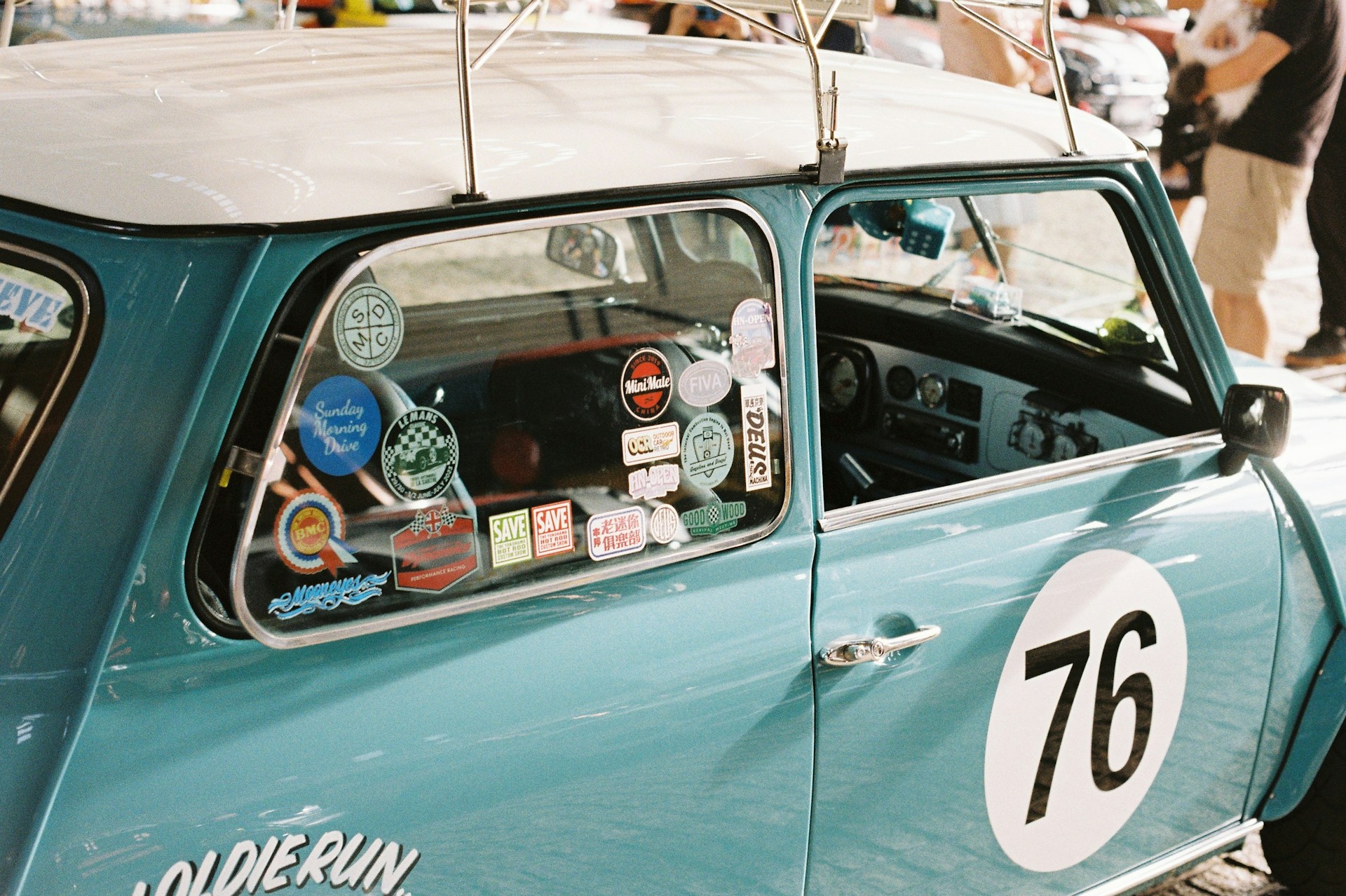 Teal classic mini cooper with racing number 76