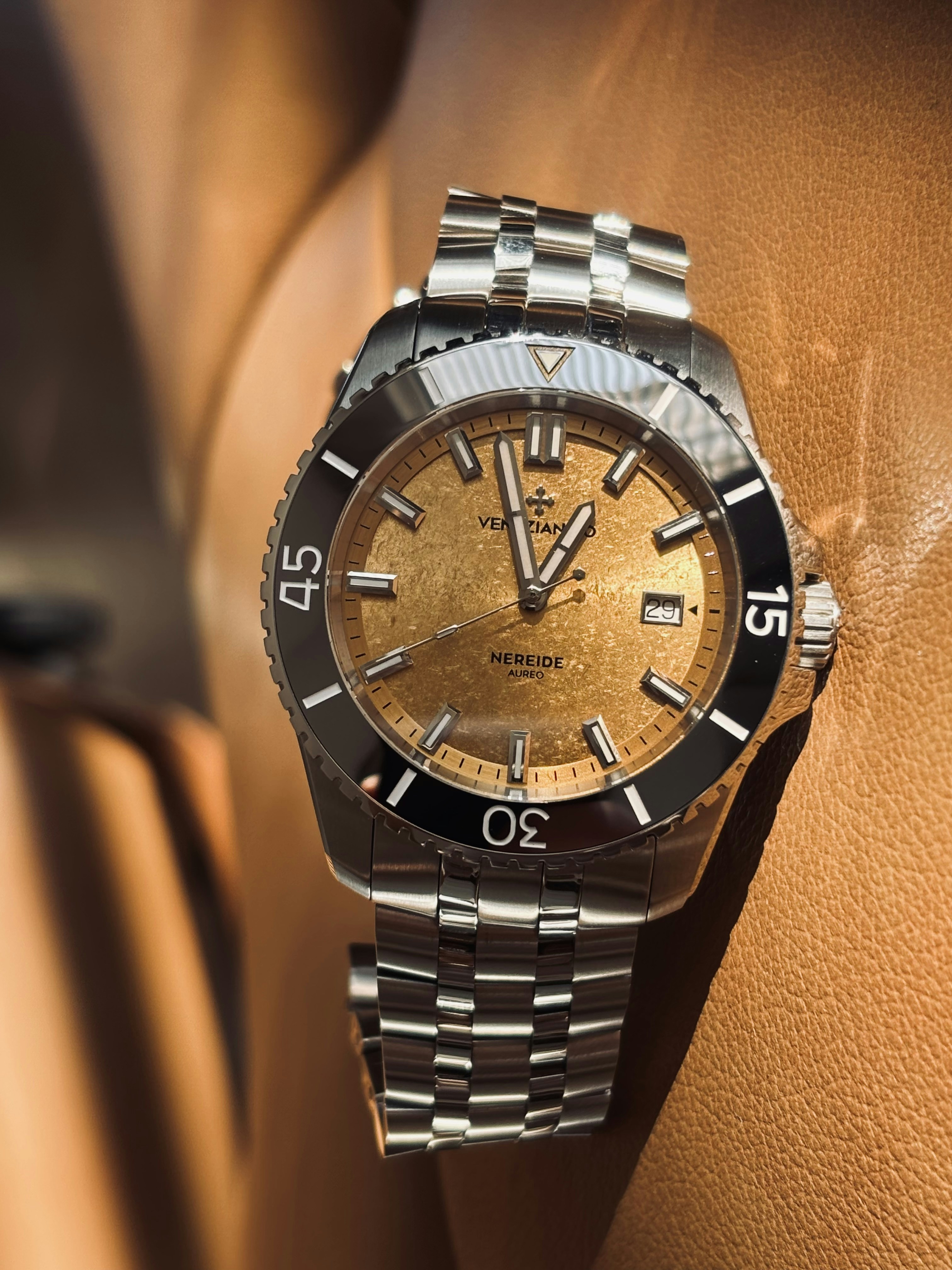 A close-up of a gold dial dive watch.