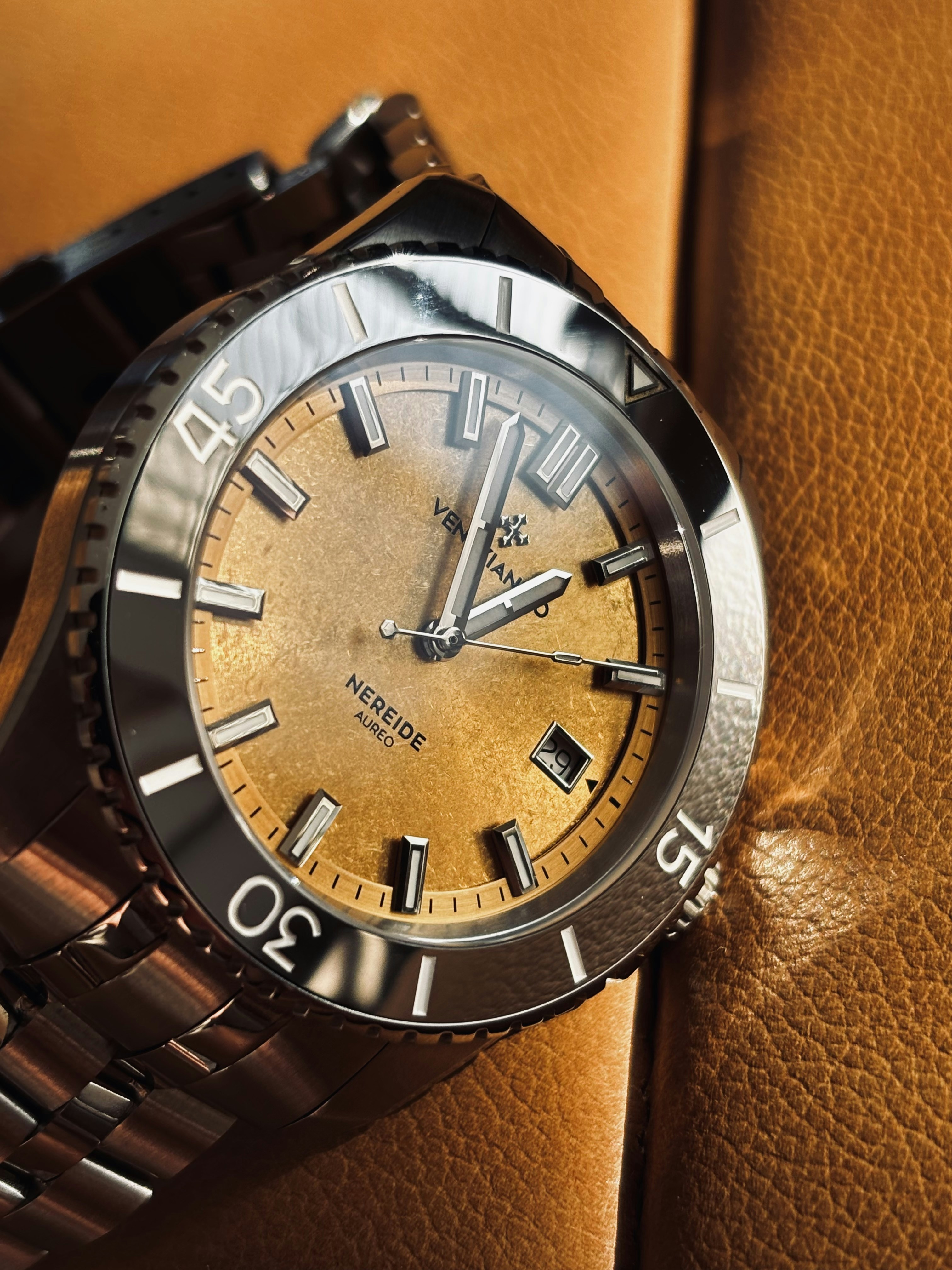 Close-up of a vintage-style watch with a golden dial.