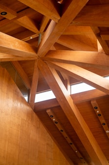 Wooden beams forming a geometric ceiling pattern.