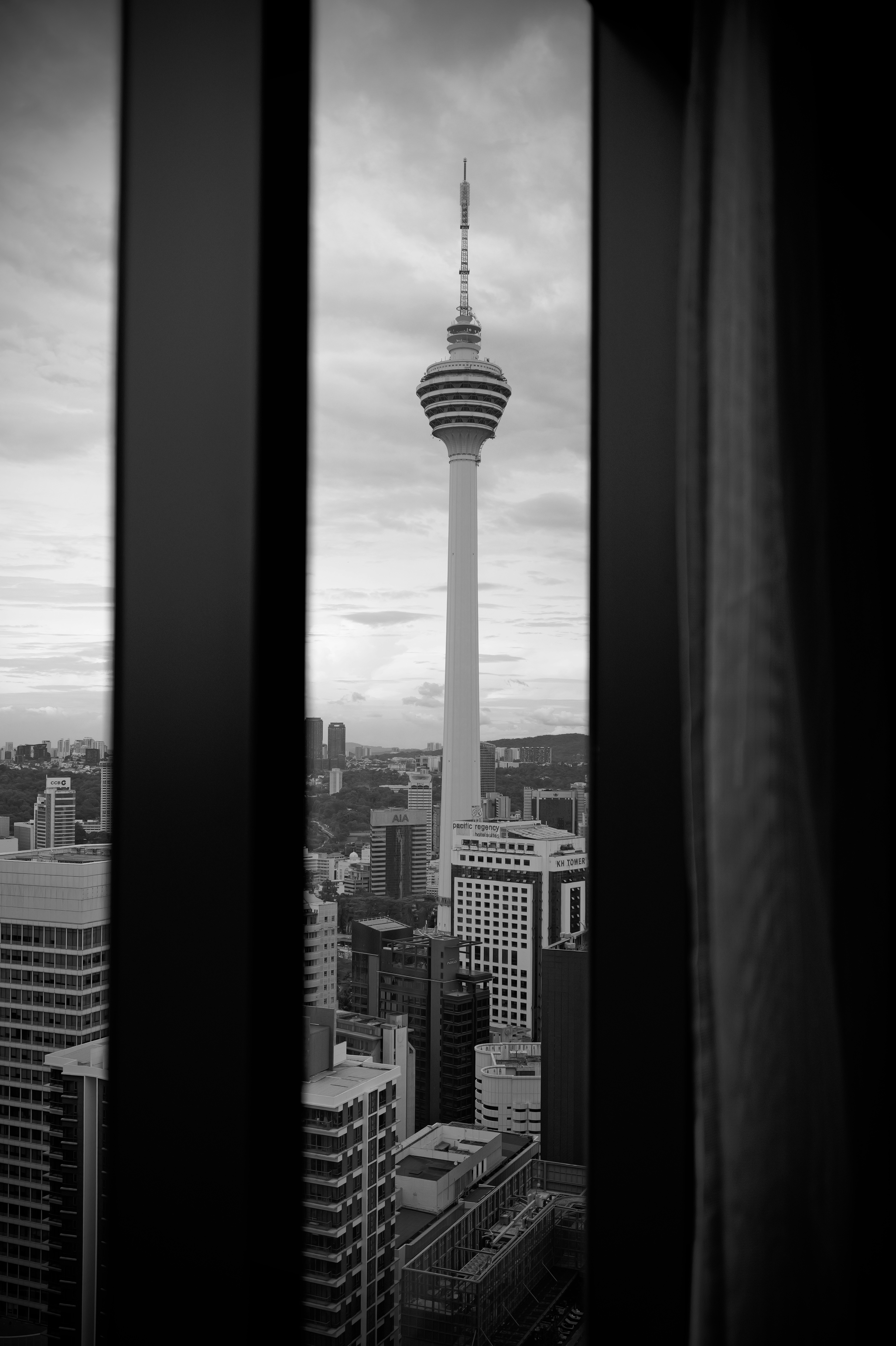 Tall tower overlooking cityscape through window bars