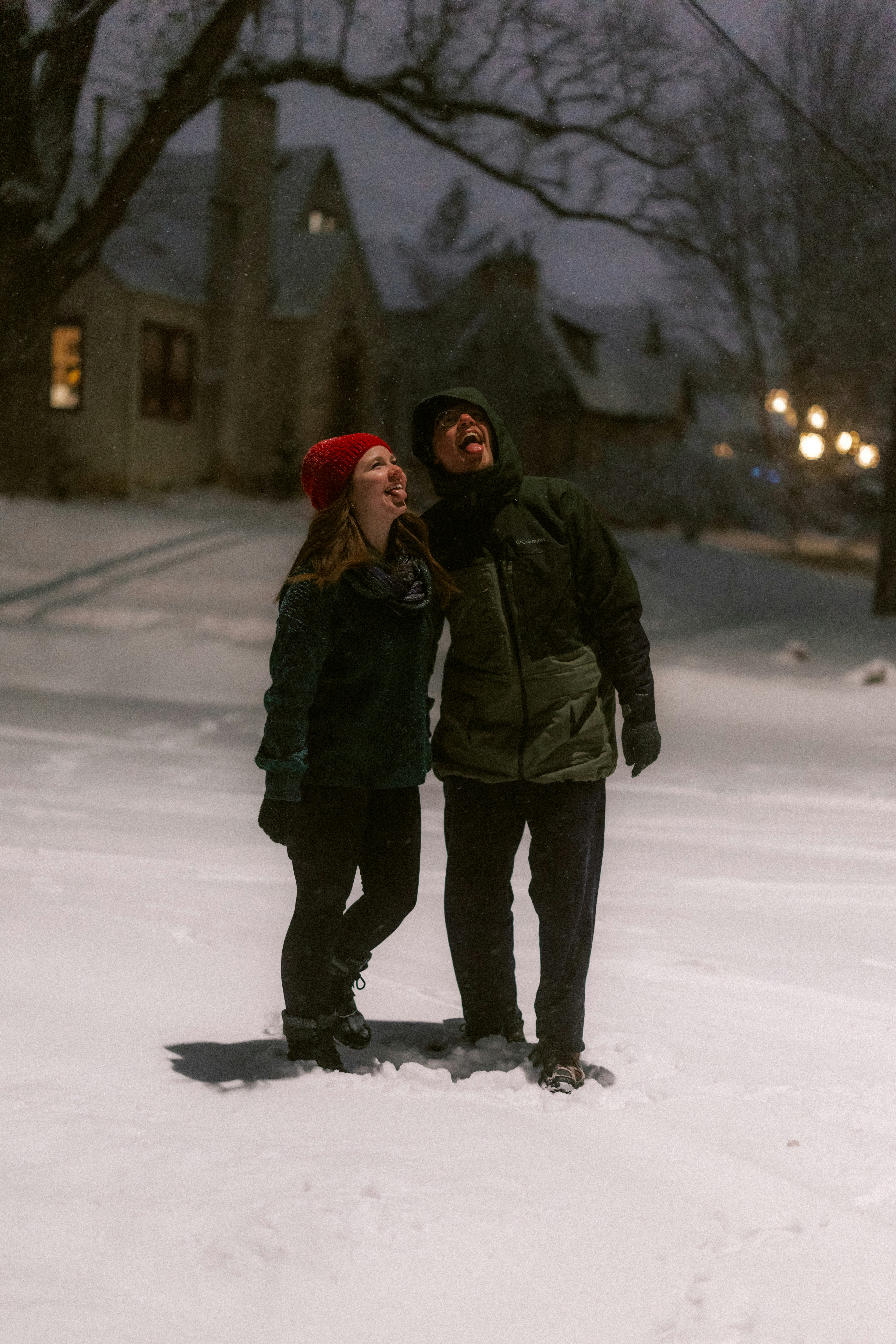 Couple enjoying snowfall at night