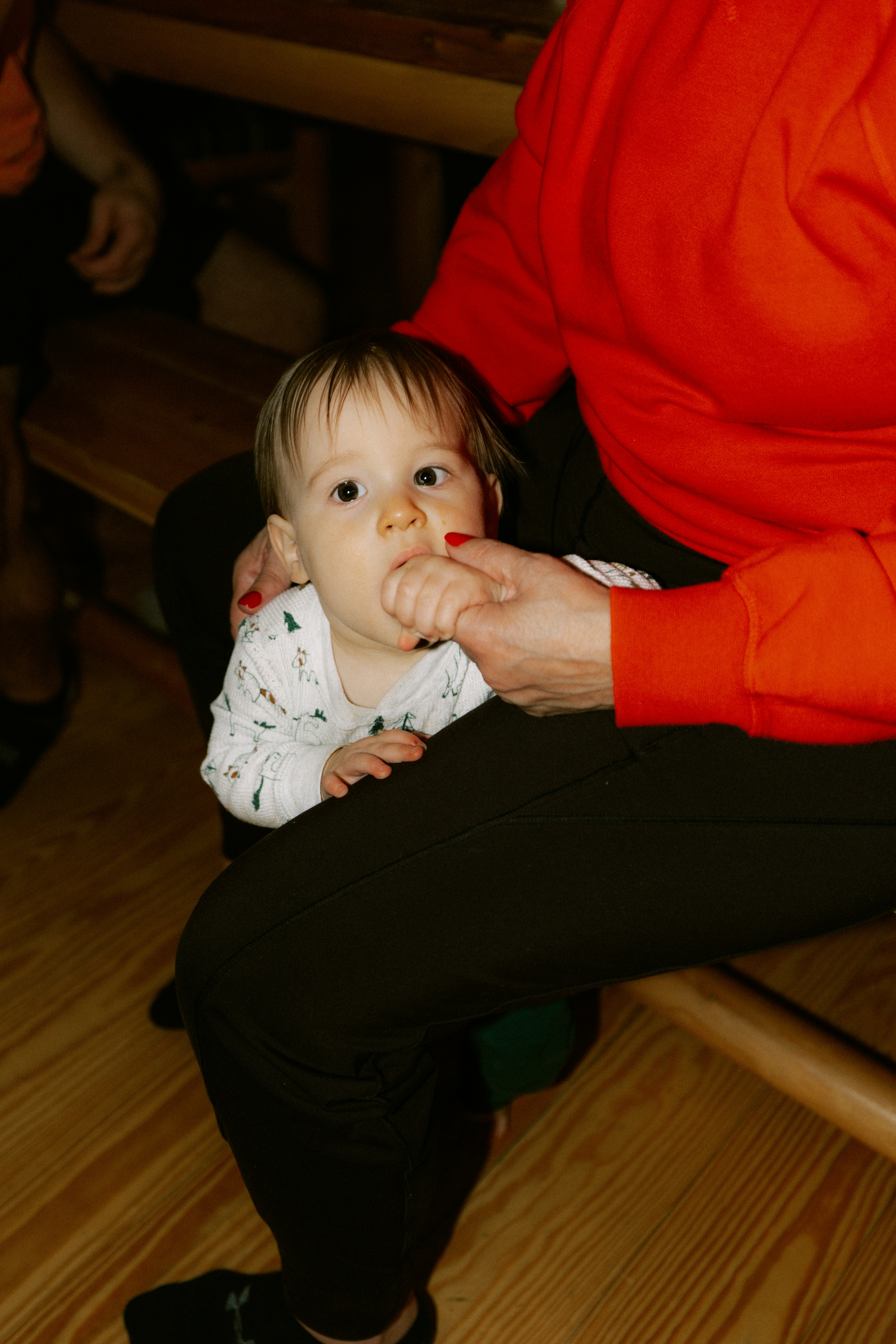 Baby sitting on a person's lap