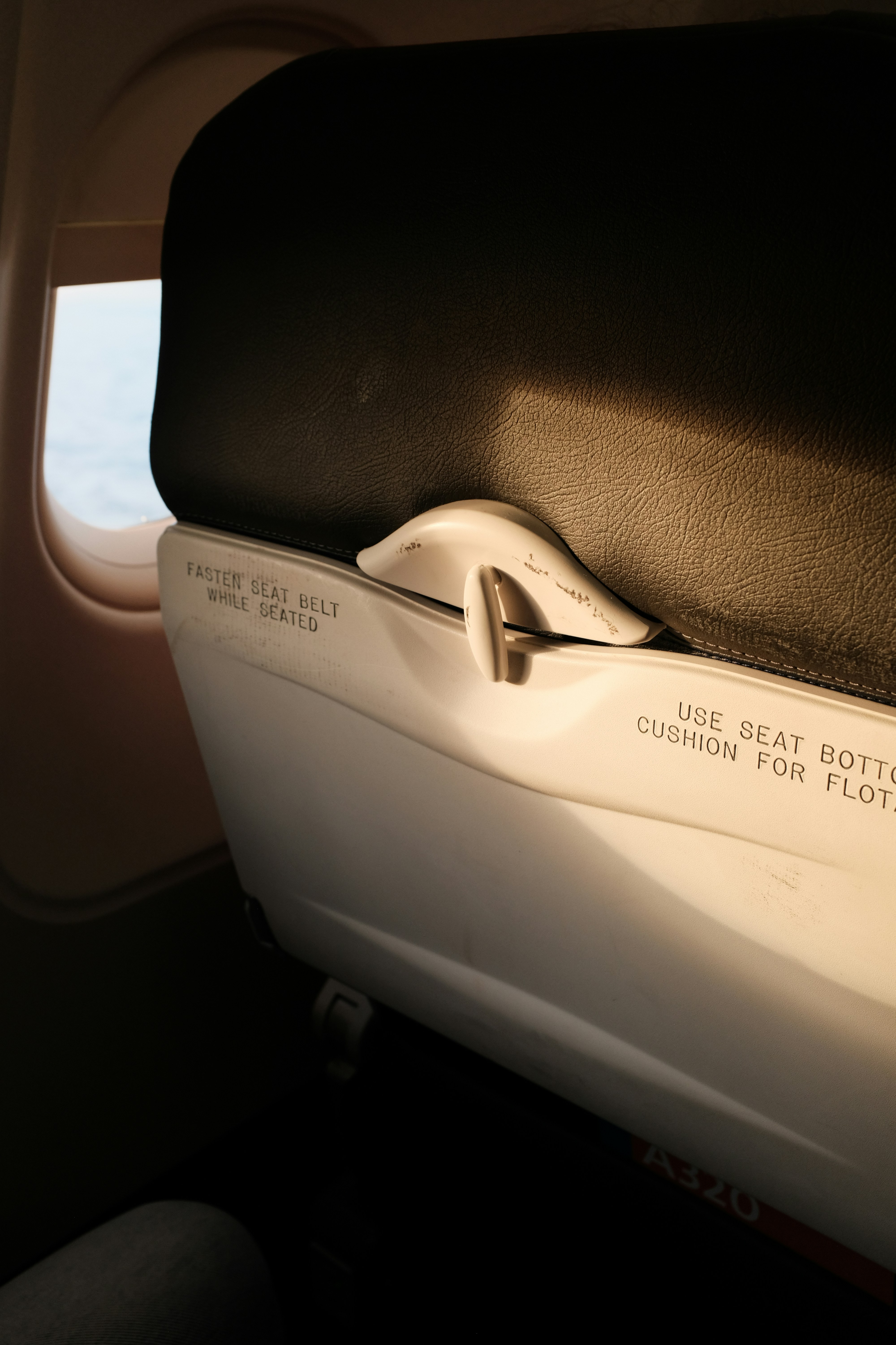 Airplane seat and window with sunlight