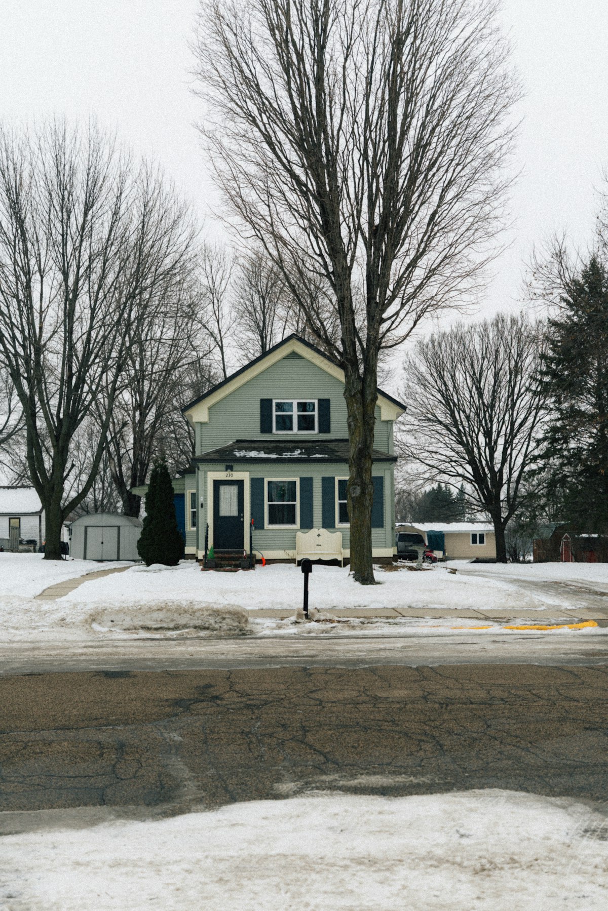 Light blue house in a snowy landscape - lightweight ergonomic snow shovel