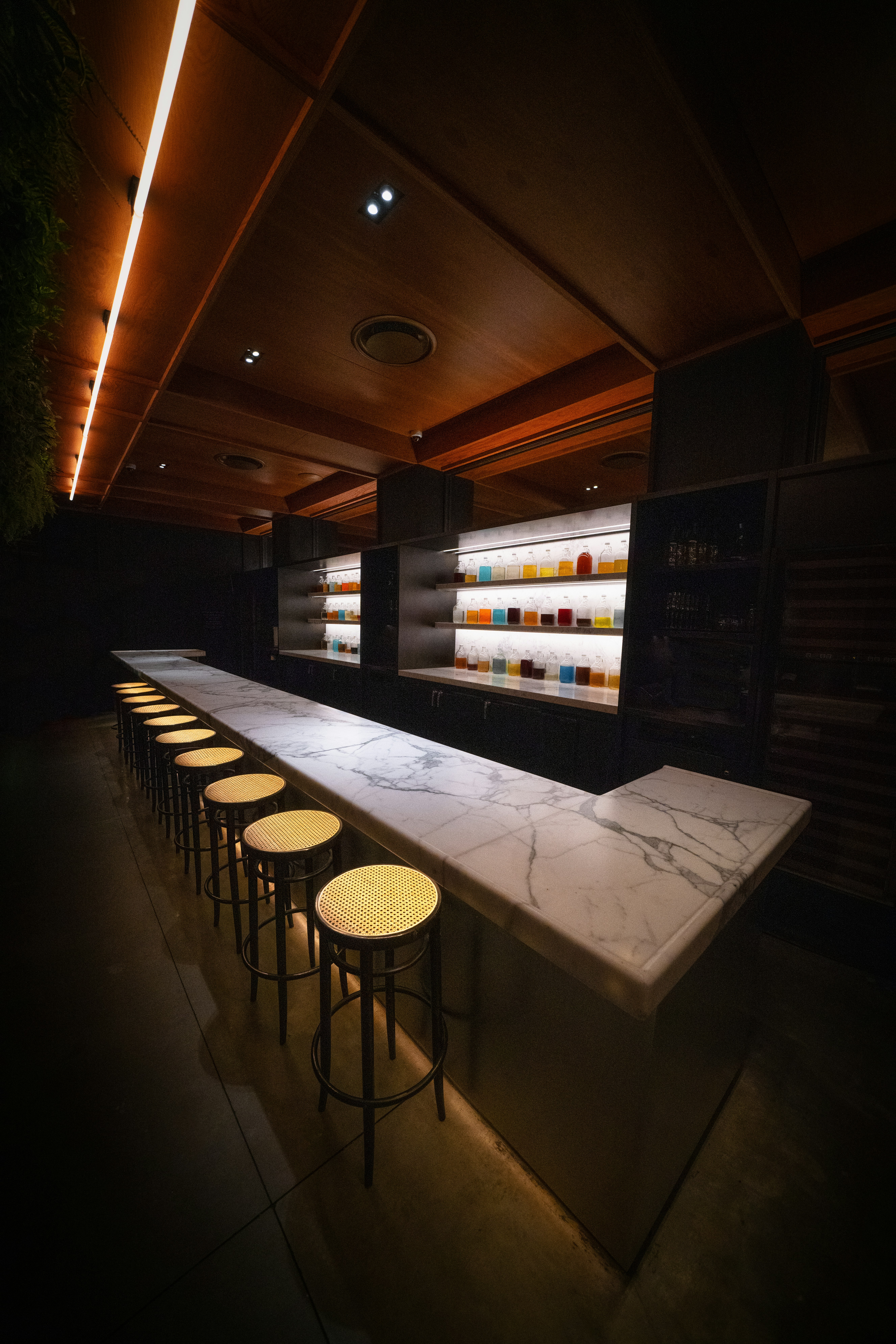 Modern bar with marble counter and stools