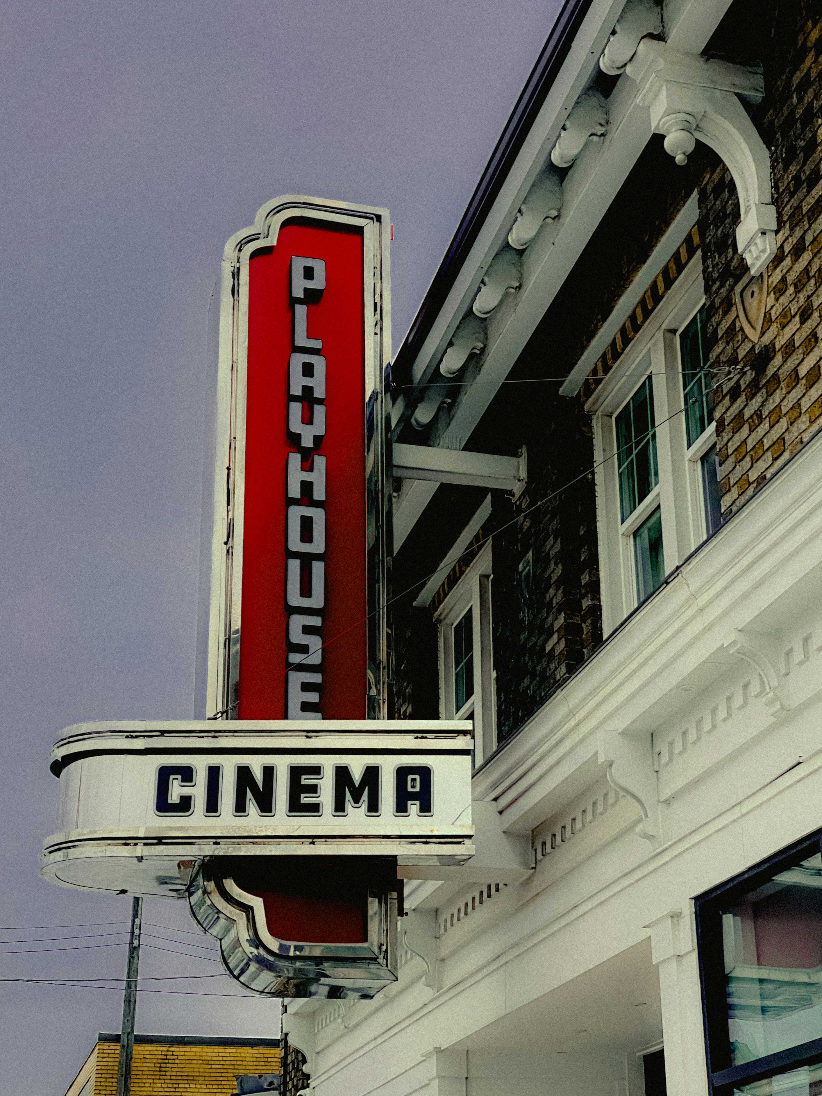 Vintage playhouse cinema sign on brick building
