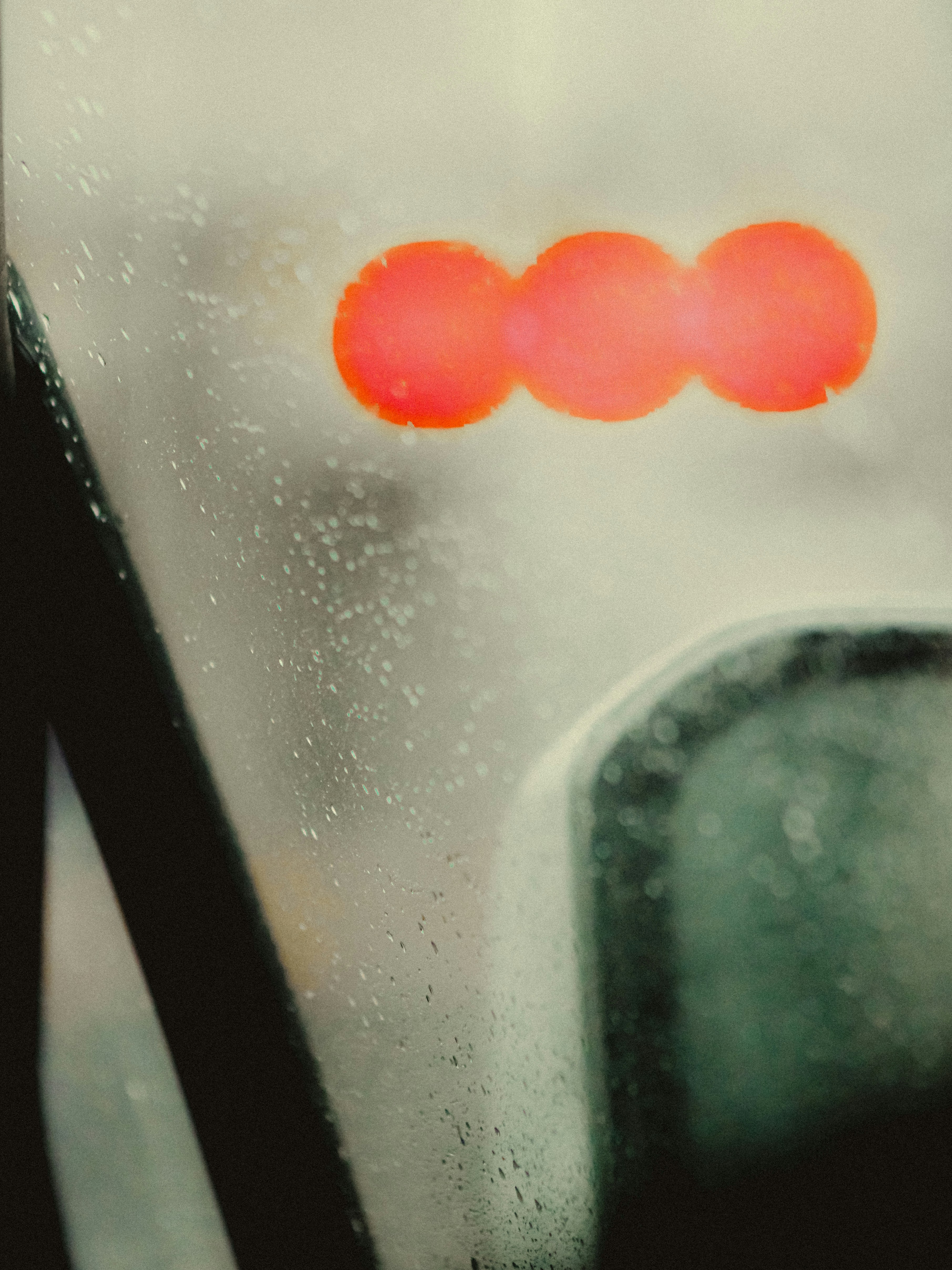 Three red circles on a foggy window