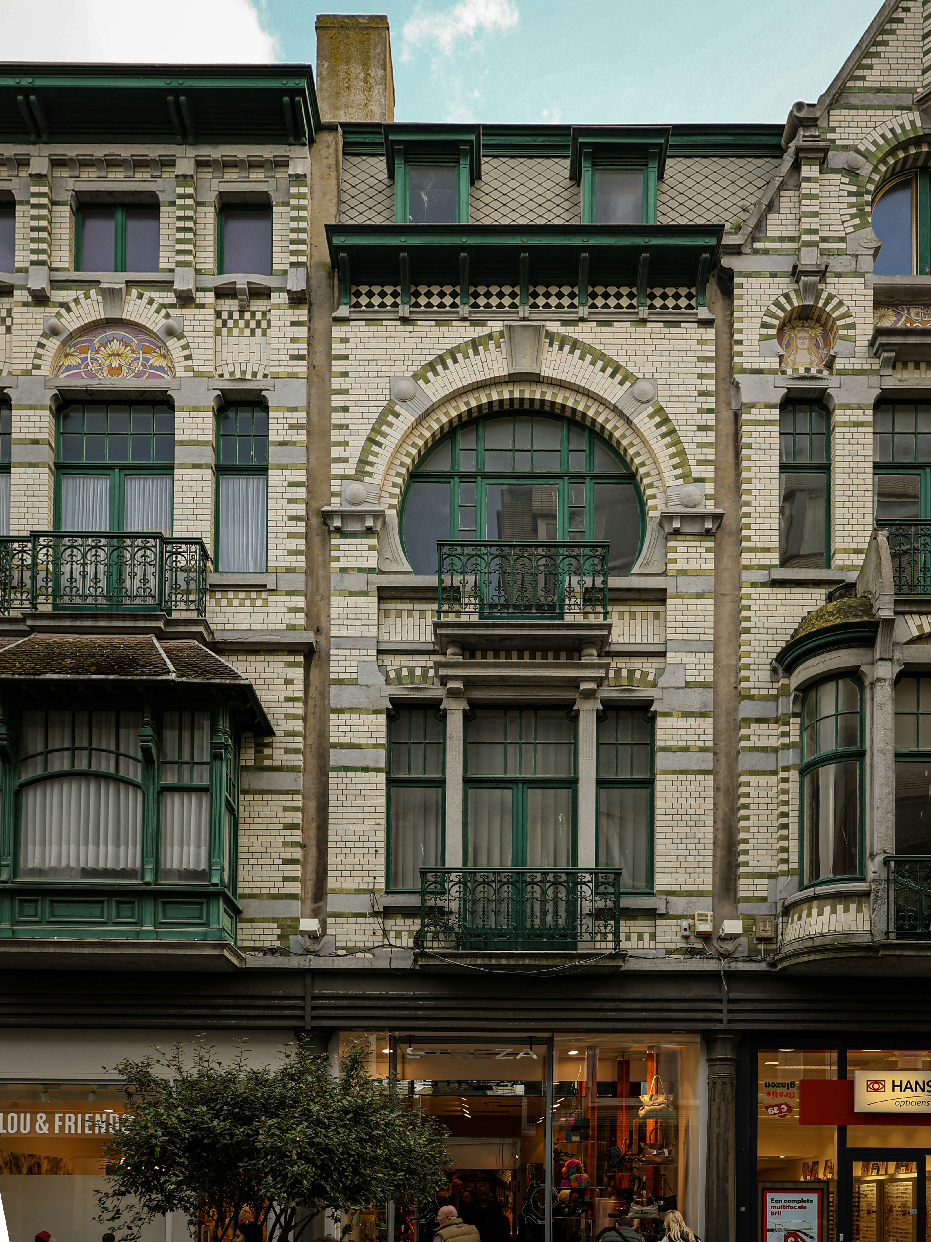 Ornate building facade with green window frames