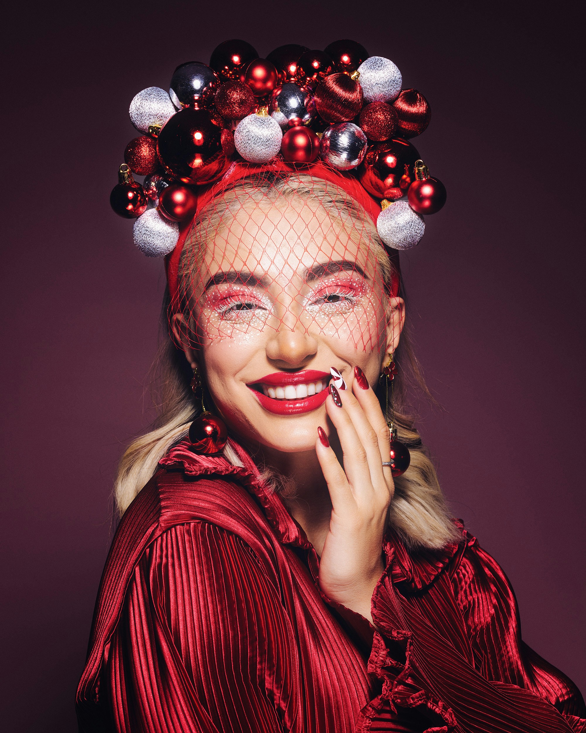 Woman with festive christmas ornament headdress and makeup