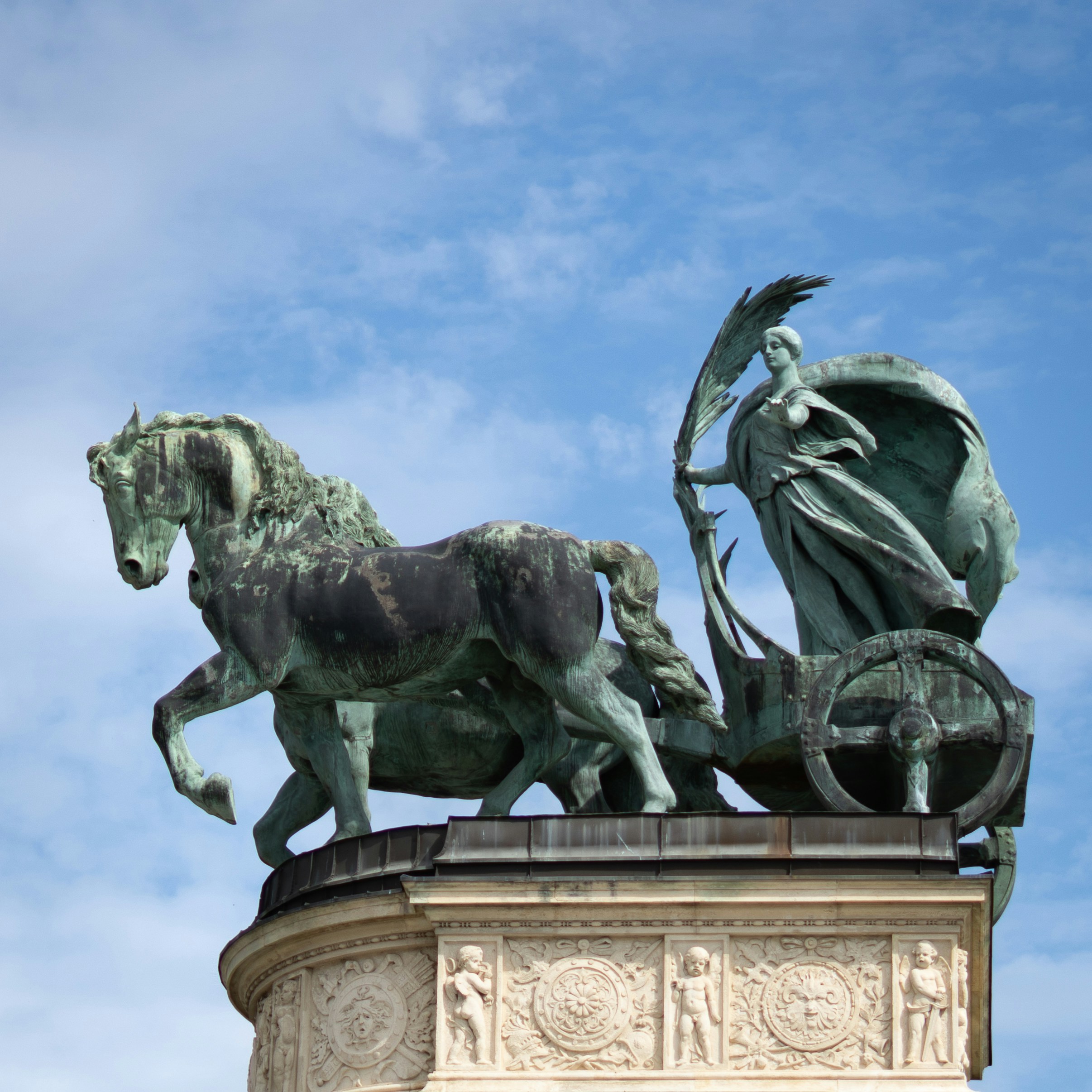 Bronze statue of a horse-drawn chariot with a woman