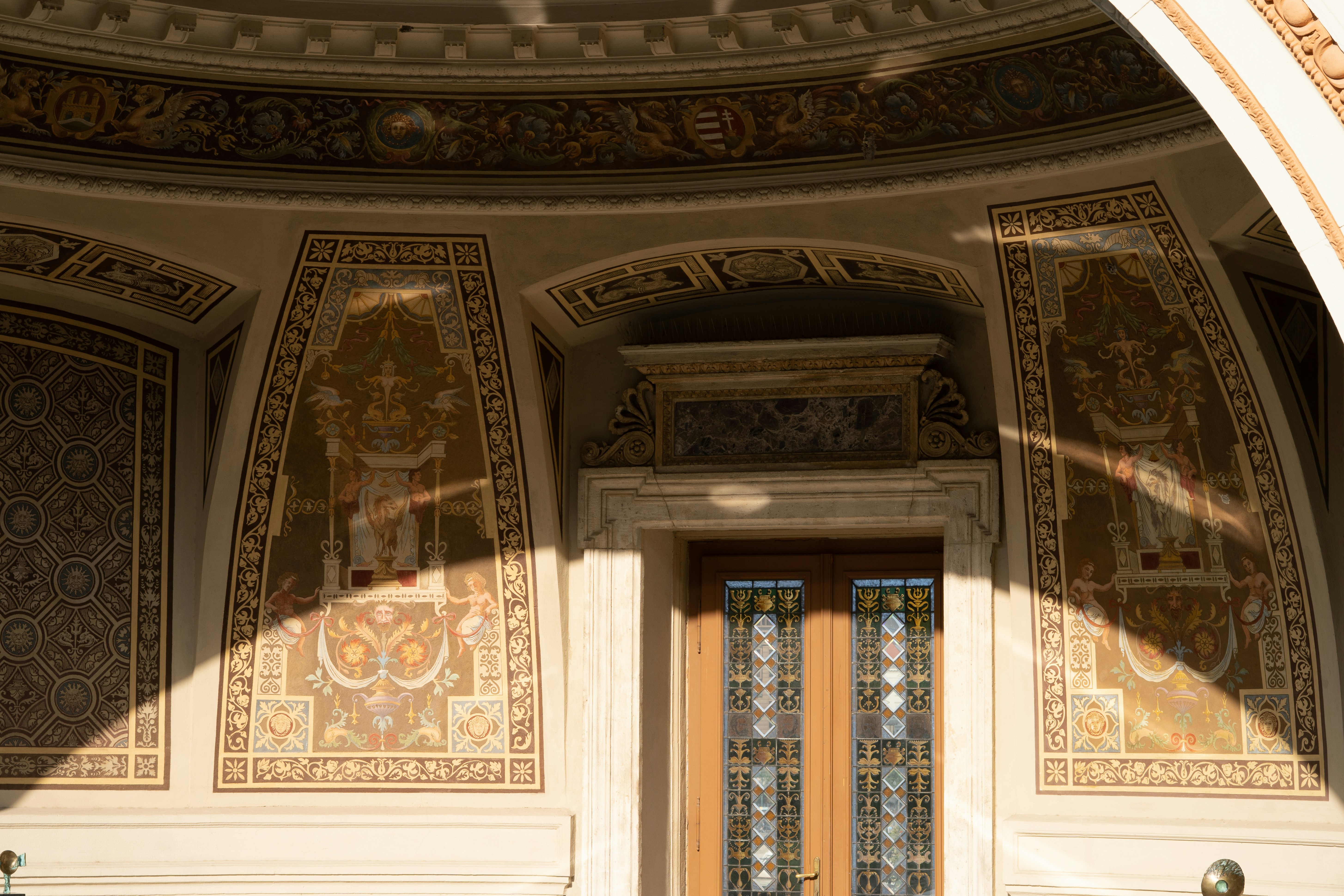 Ornate architectural entrance with decorative panels and glass doors